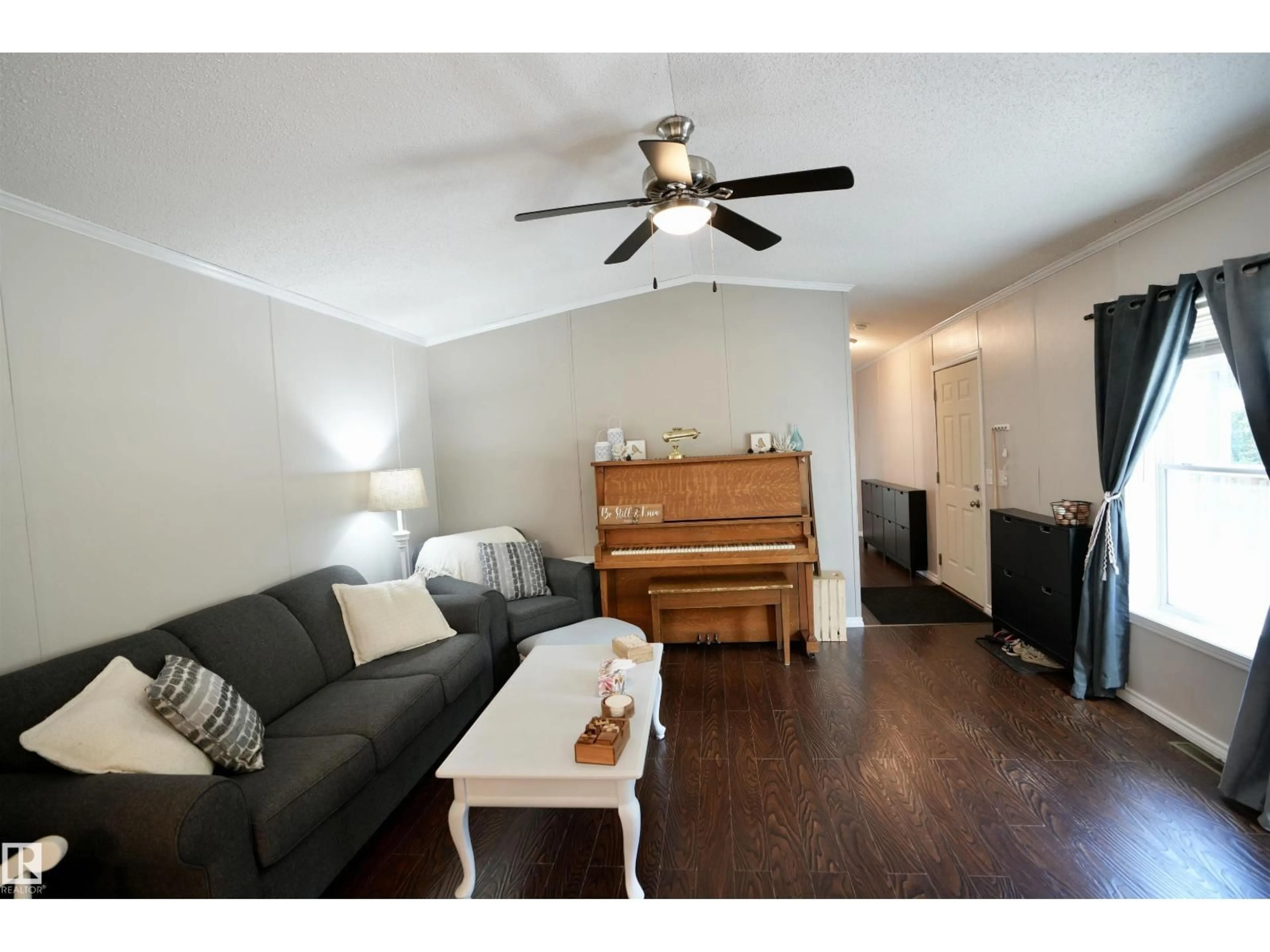 Living room with furniture, wood/laminate floor for 113 - 111 58532 RR, Rural St. Paul County Alberta T0A0C0