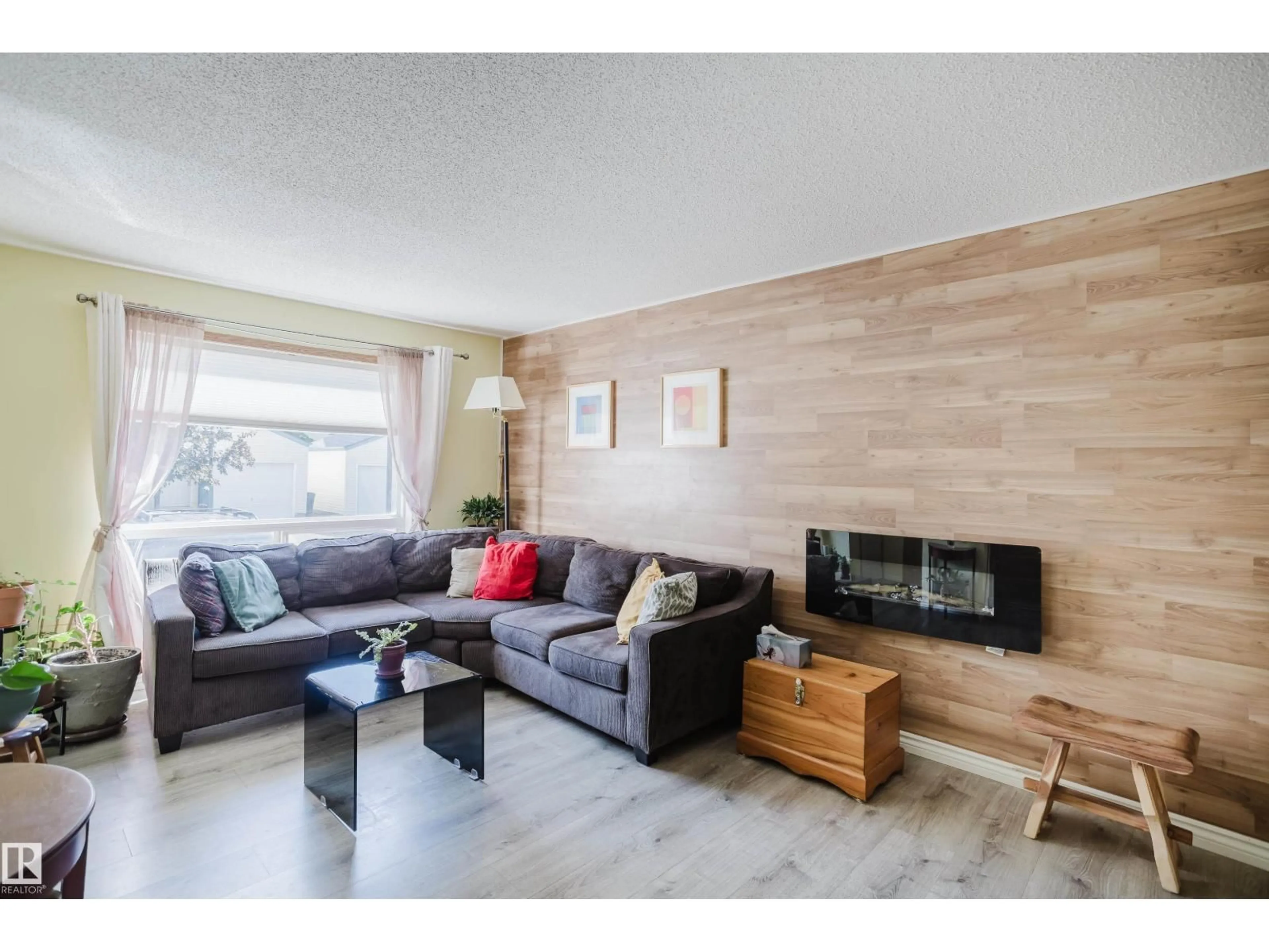 Living room with furniture, wood/laminate floor for 20 10909 106 ST NW, Edmonton Alberta T5H4M7