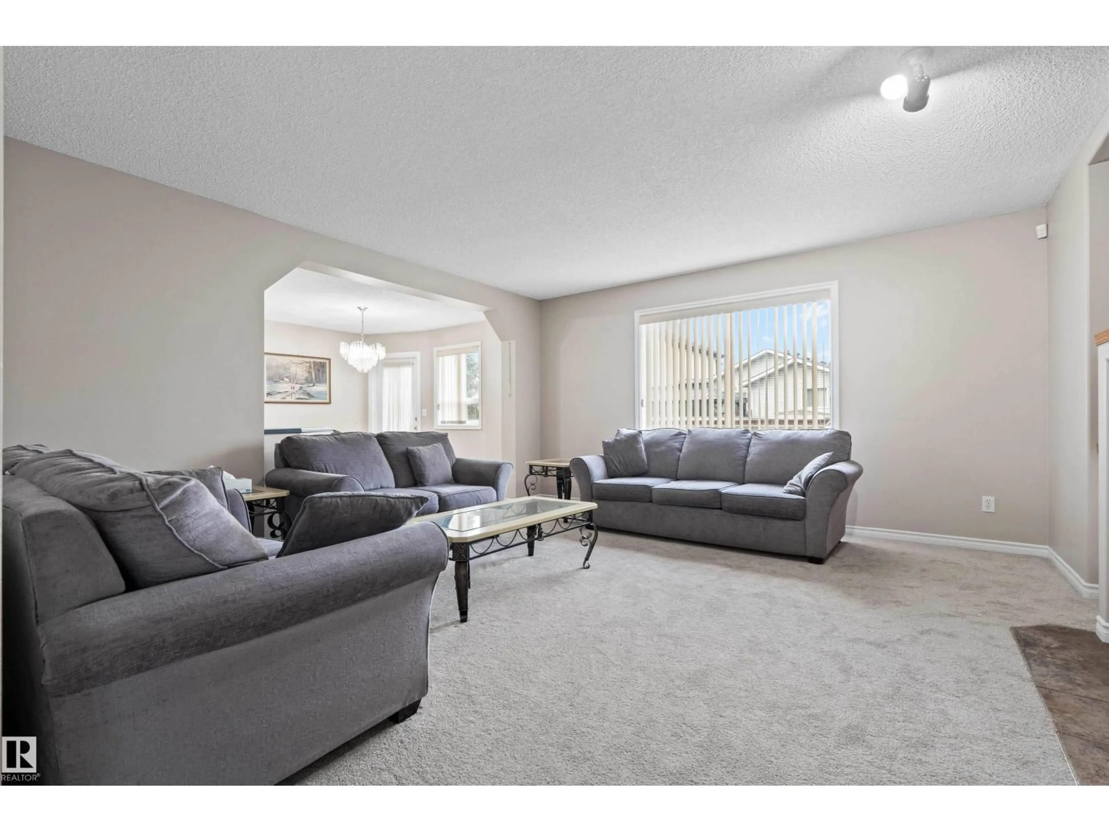 Living room with furniture, carpet floor for 4804 147 AV, Edmonton Alberta T5Y2X2