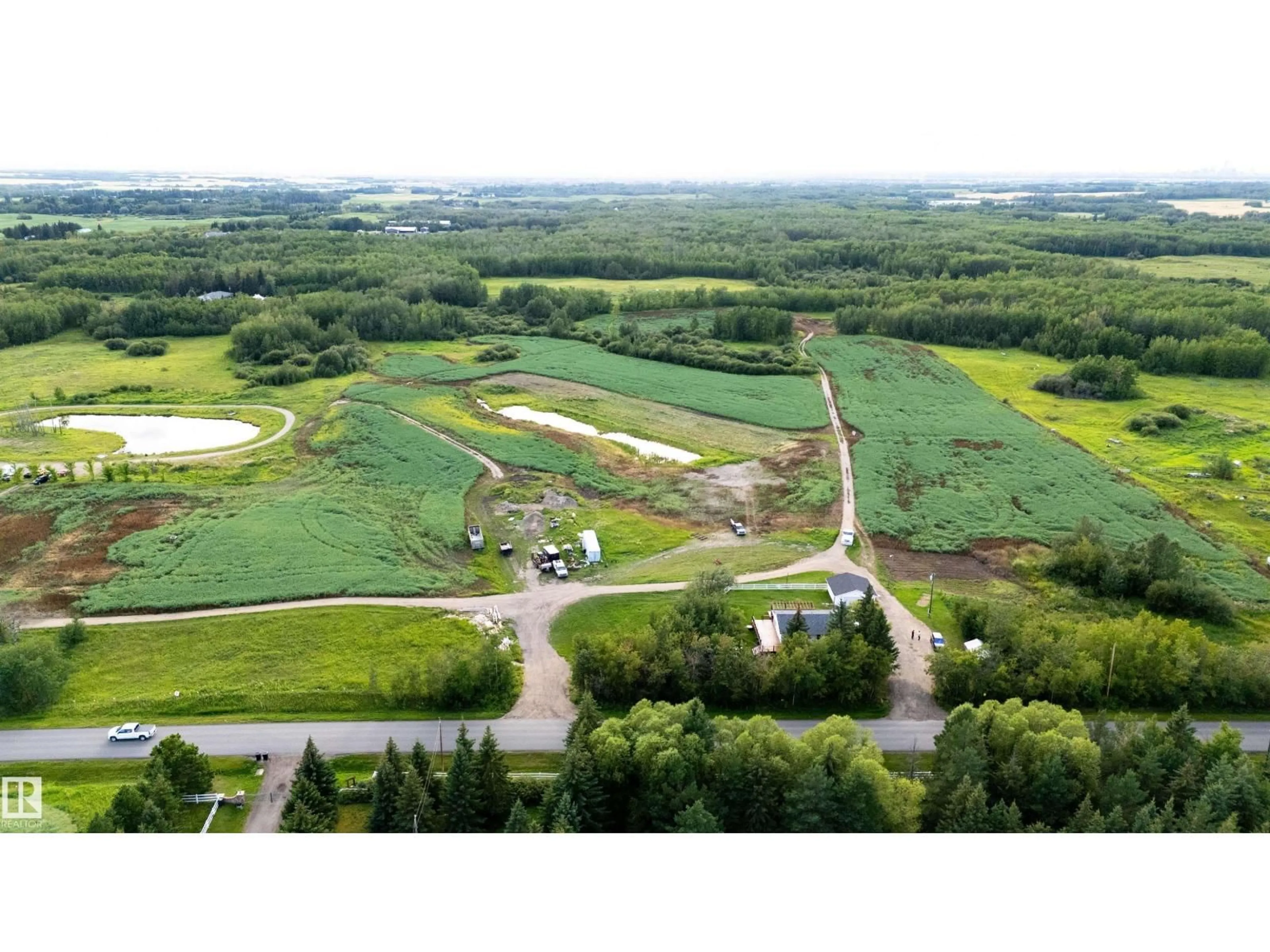 A pic from outside/outdoor area/front of a property/back of a property/a pic from drone, water/lake/river/ocean view for 52028 RANGE RD 231, Rural Strathcona County Alberta T8B1A3