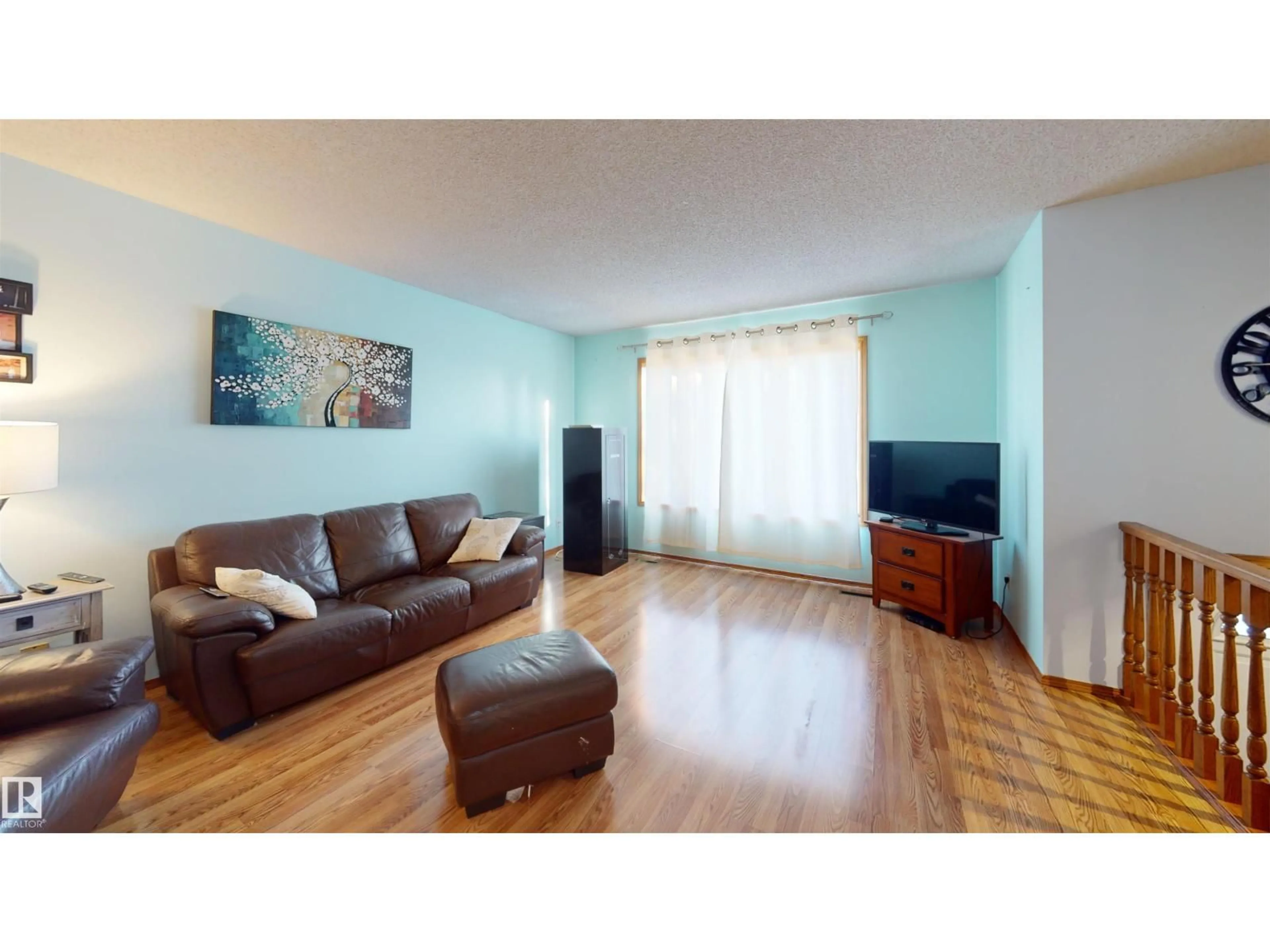 Living room with furniture, wood/laminate floor for 4916 31 AV, Edmonton Alberta T6L5H6