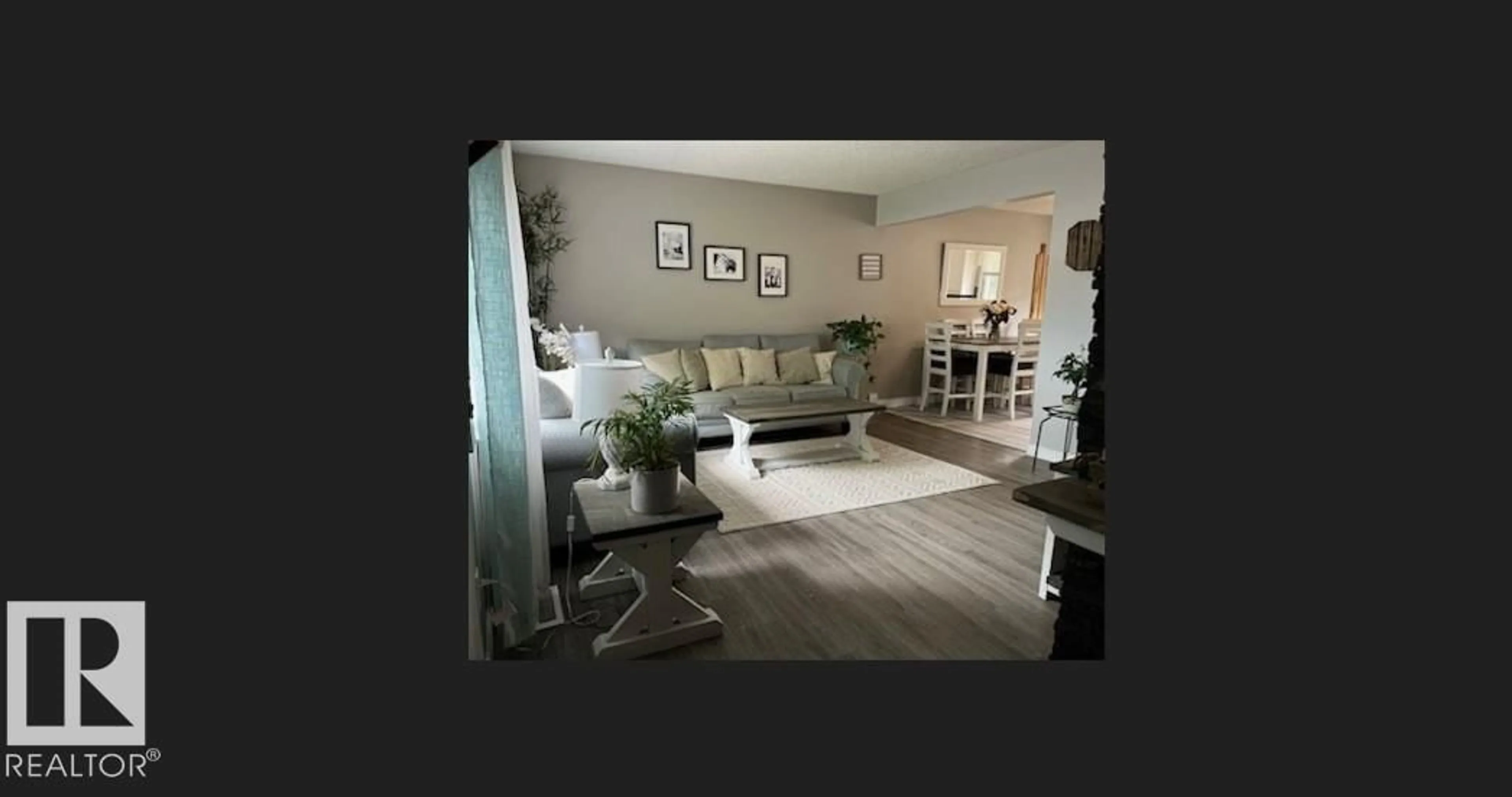 Living room with furniture, wood/laminate floor for 6420 146 AV, Edmonton Alberta T5A1T3