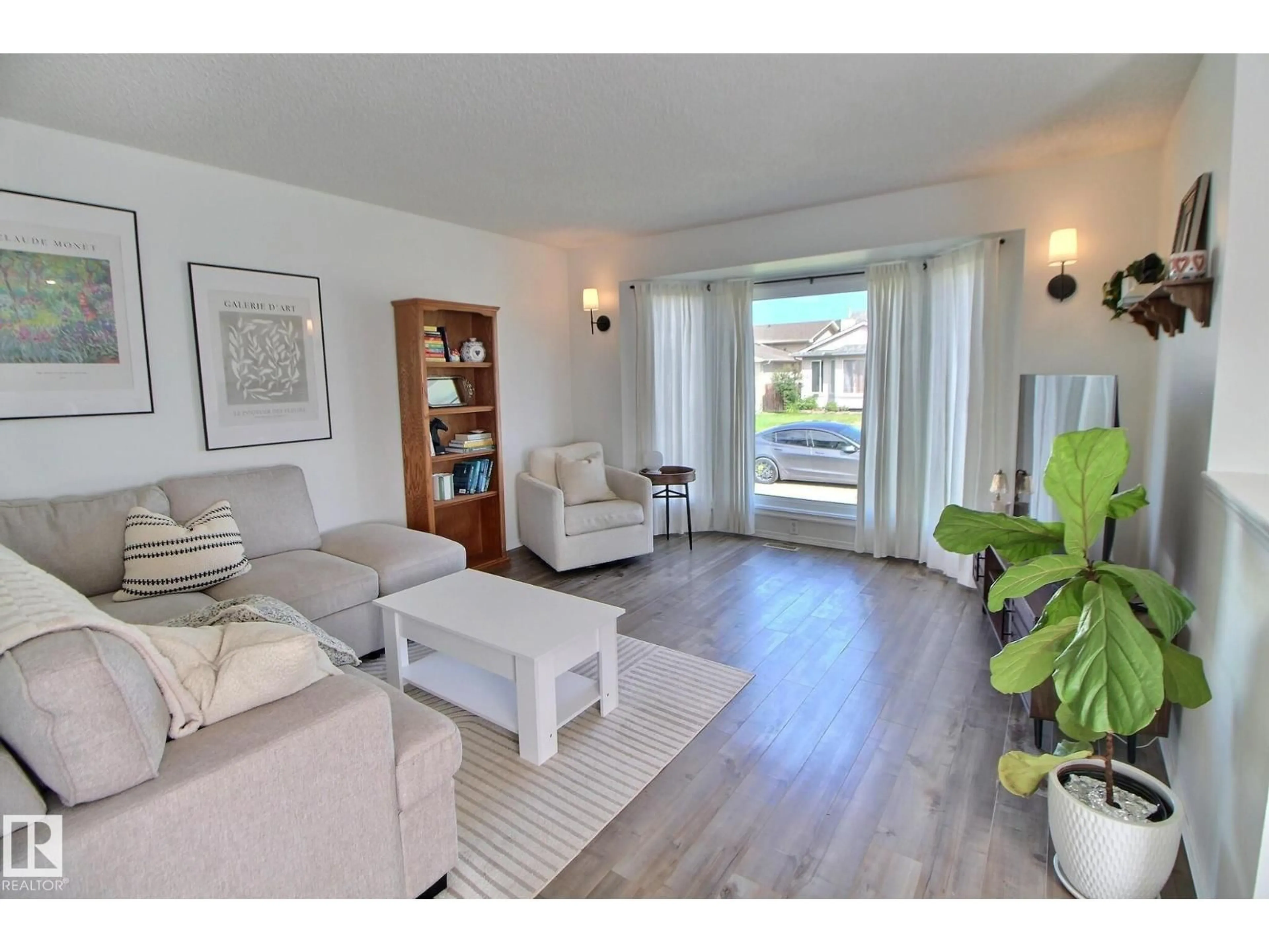 Living room with furniture, wood/laminate floor for 8335 159 AV, Edmonton Alberta T5Z3C8