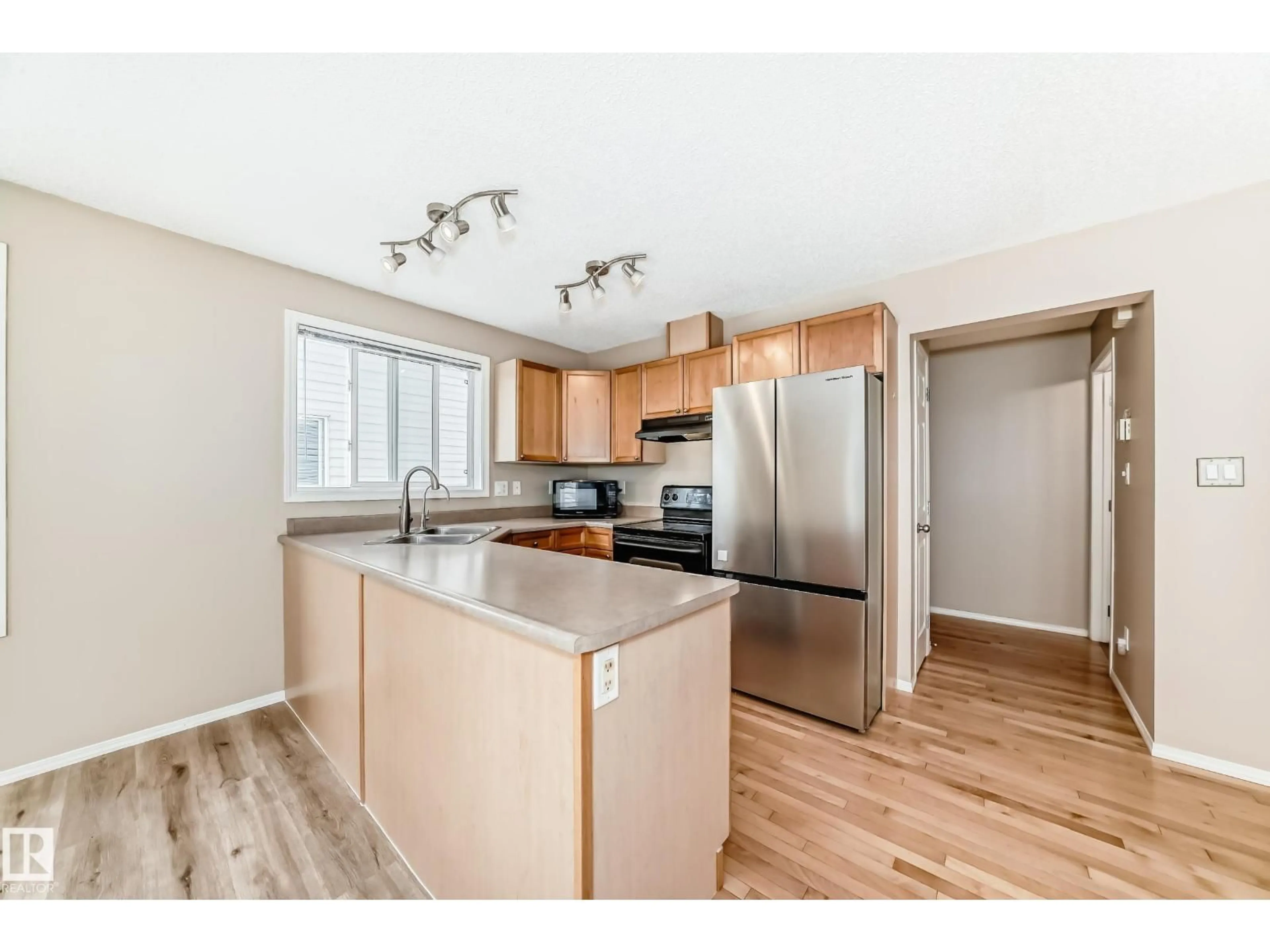 Open concept kitchen, wood/laminate floor for 451 - 46 HYNDMAN CRESCENT, Edmonton Alberta T5A5J3