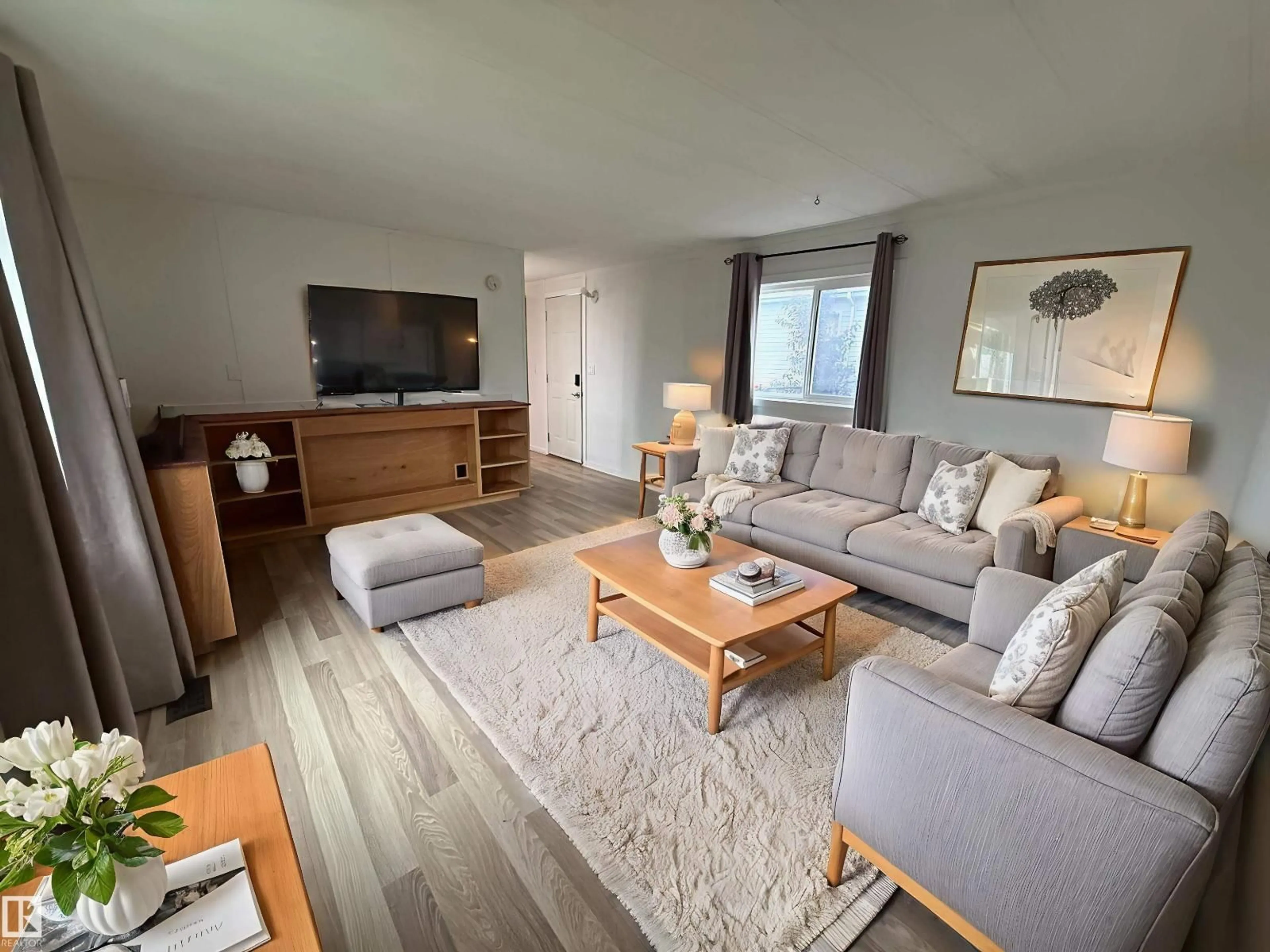 Living room with furniture, wood/laminate floor for 812 53222 RGE RD 272, Rural Parkland County Alberta T7X3R2
