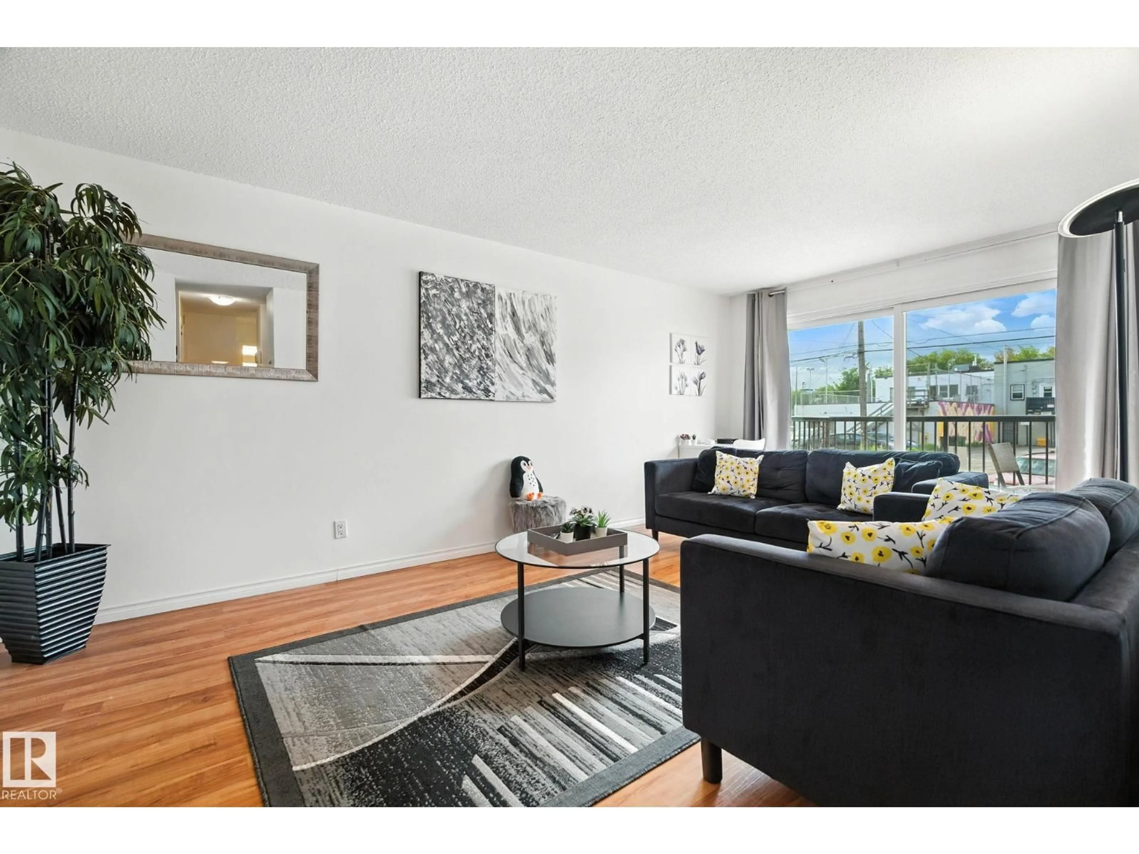 Living room with furniture, wood/laminate floor for 202 - 10149 83 AV, Edmonton Alberta T6E2C5