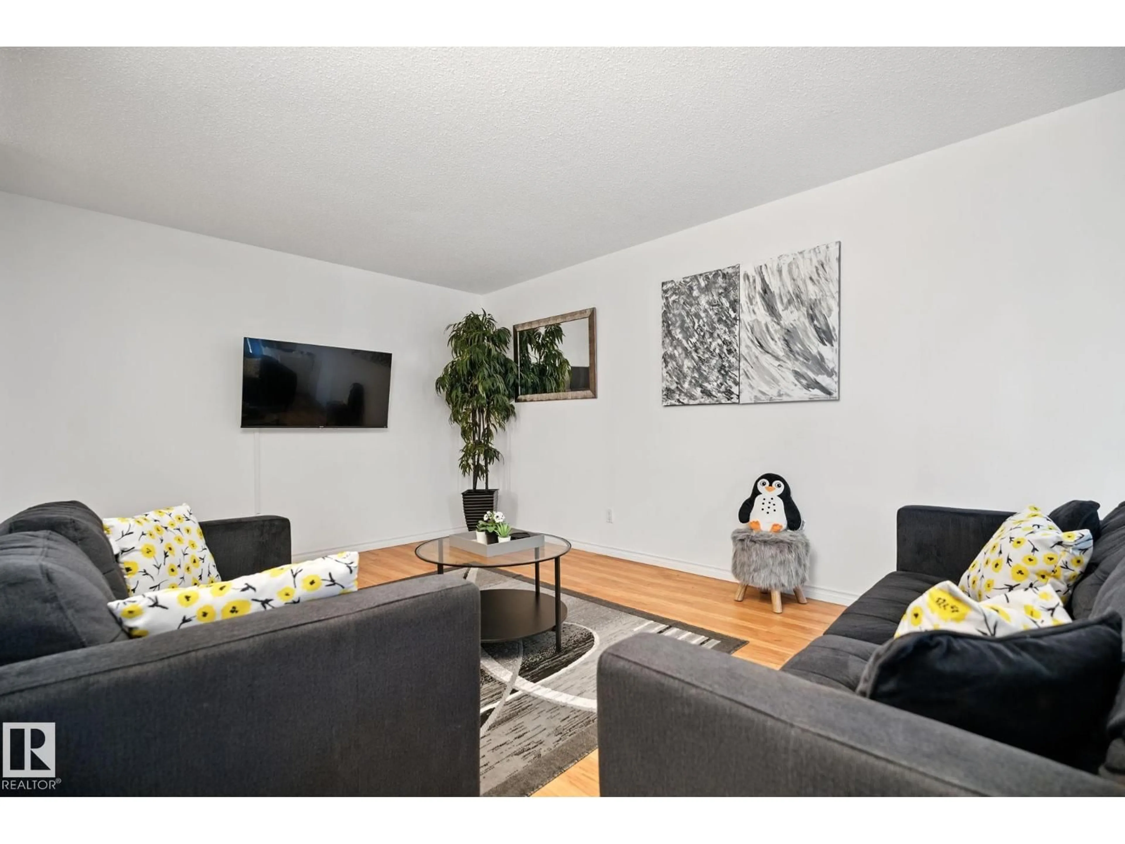 Living room with furniture, wood/laminate floor for 202 - 10149 83 AV, Edmonton Alberta T6E2C5