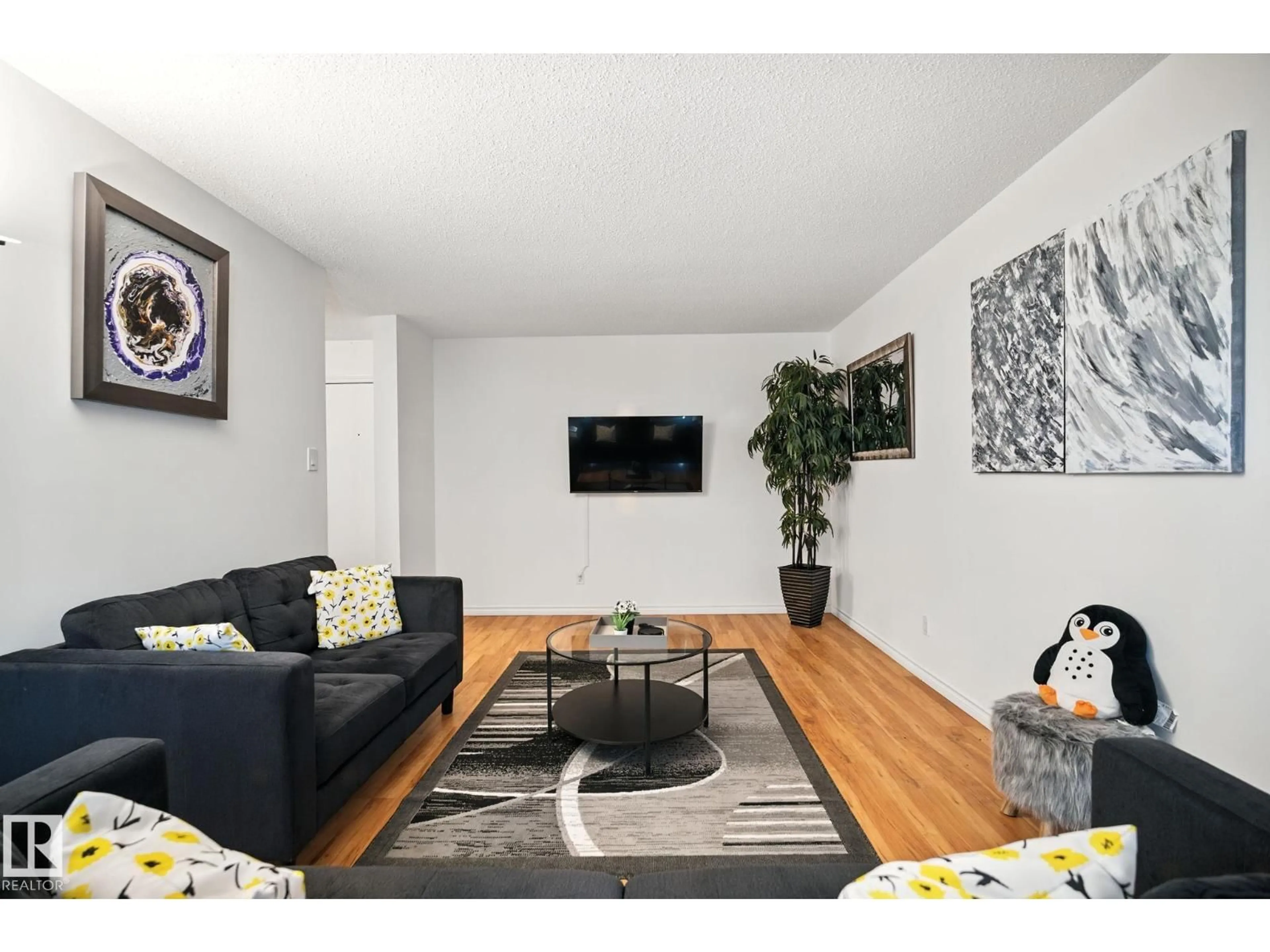Living room with furniture, wood/laminate floor for 202 - 10149 83 AV, Edmonton Alberta T6E2C5
