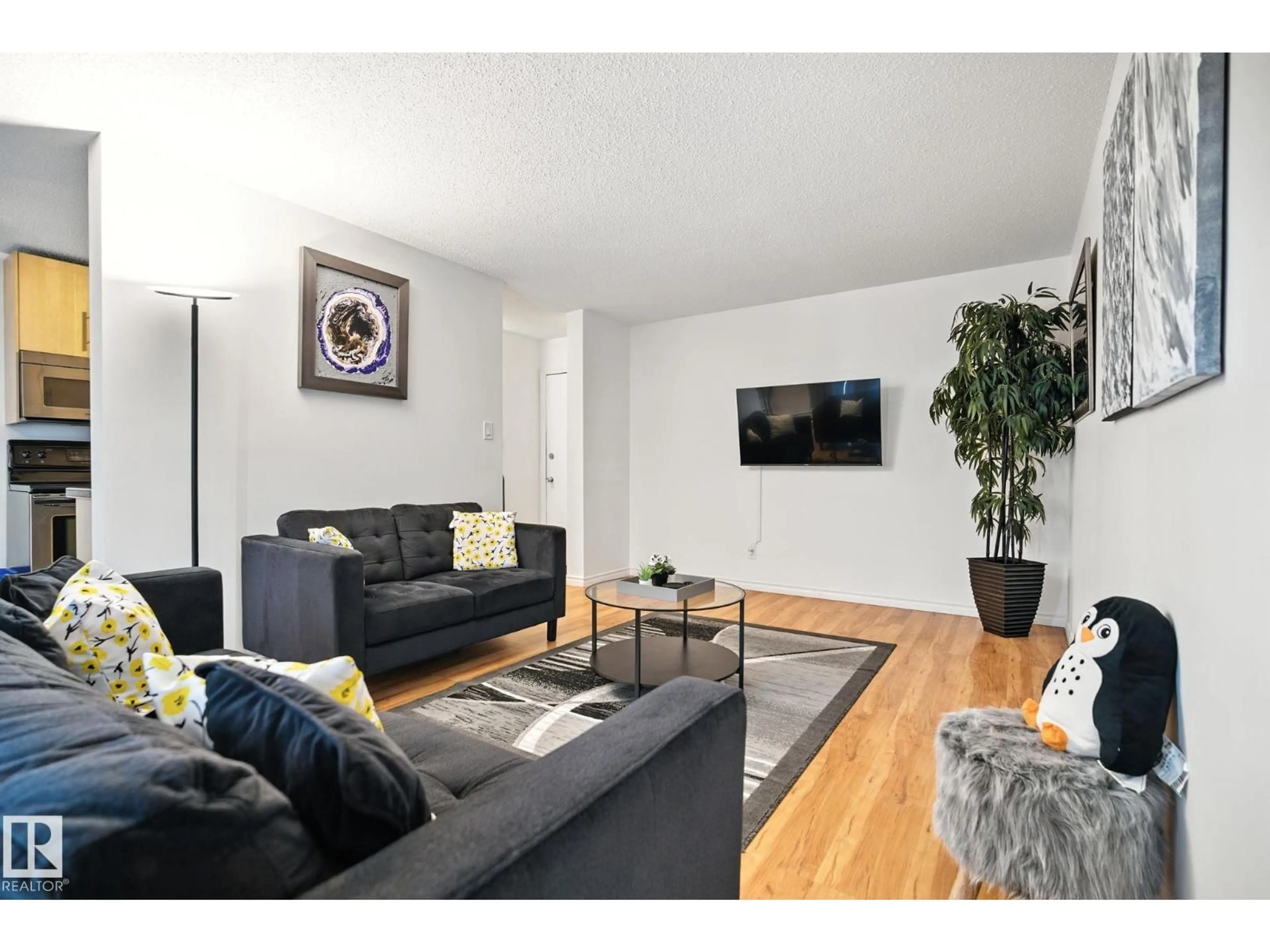 Living room with furniture, wood/laminate floor for 202 - 10149 83 AV, Edmonton Alberta T6E2C5