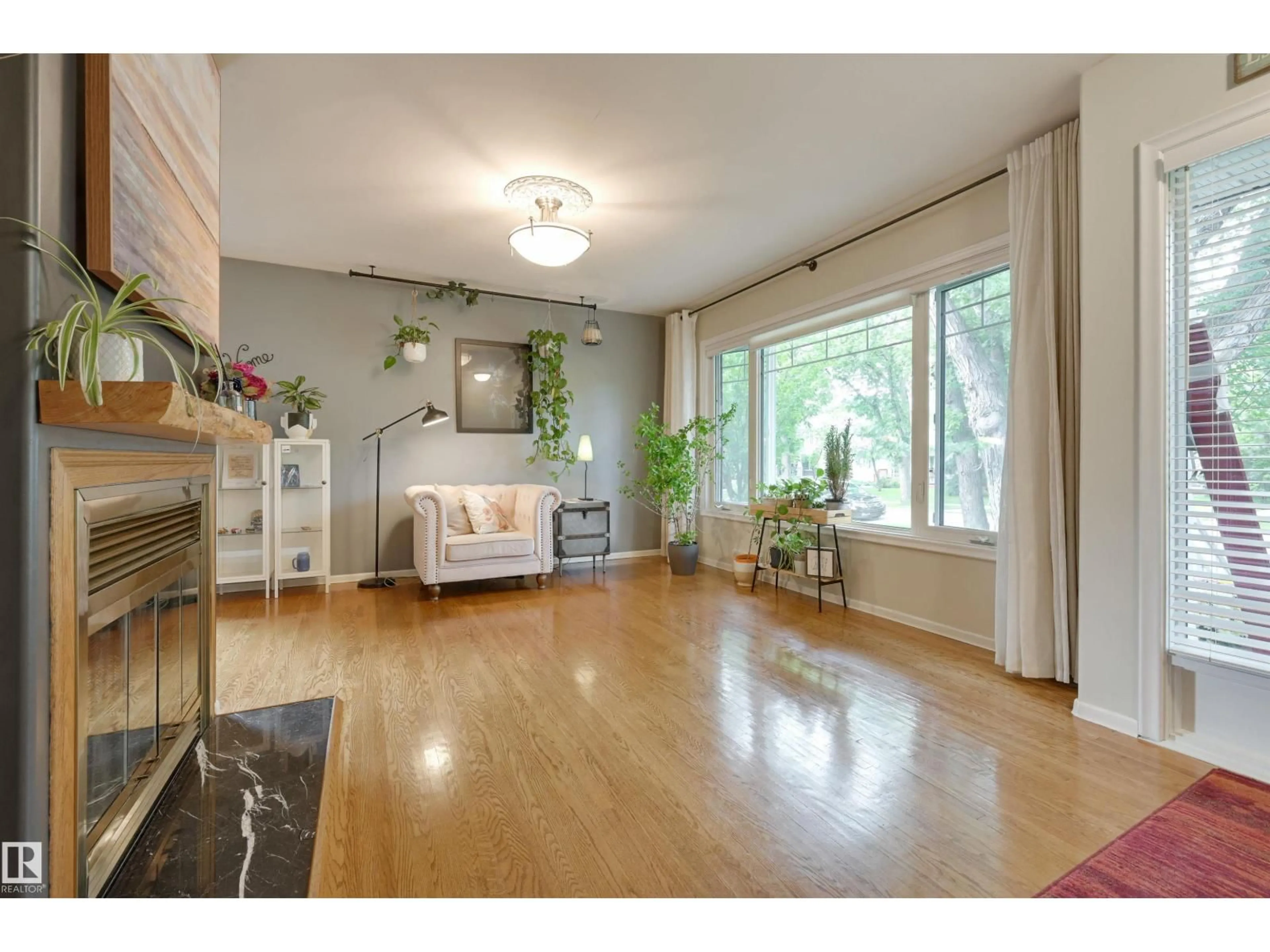 Living room with furniture, wood/laminate floor for NW - 10615 134 ST, Edmonton Alberta T5N2B7