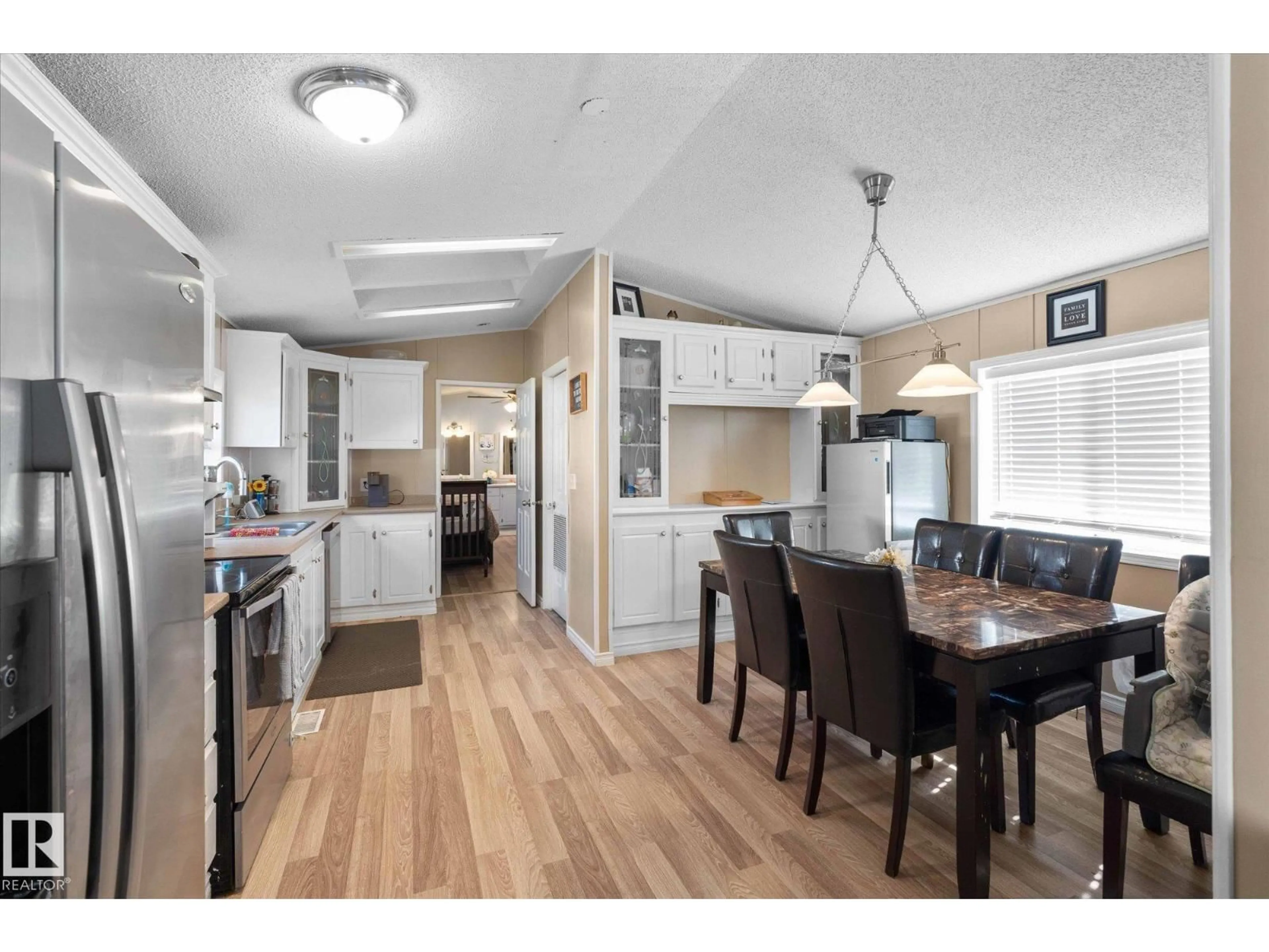 Open concept kitchen, wood/laminate floor for 1503 JUBILEE DR, Sherwood Park Alberta T8H1M1