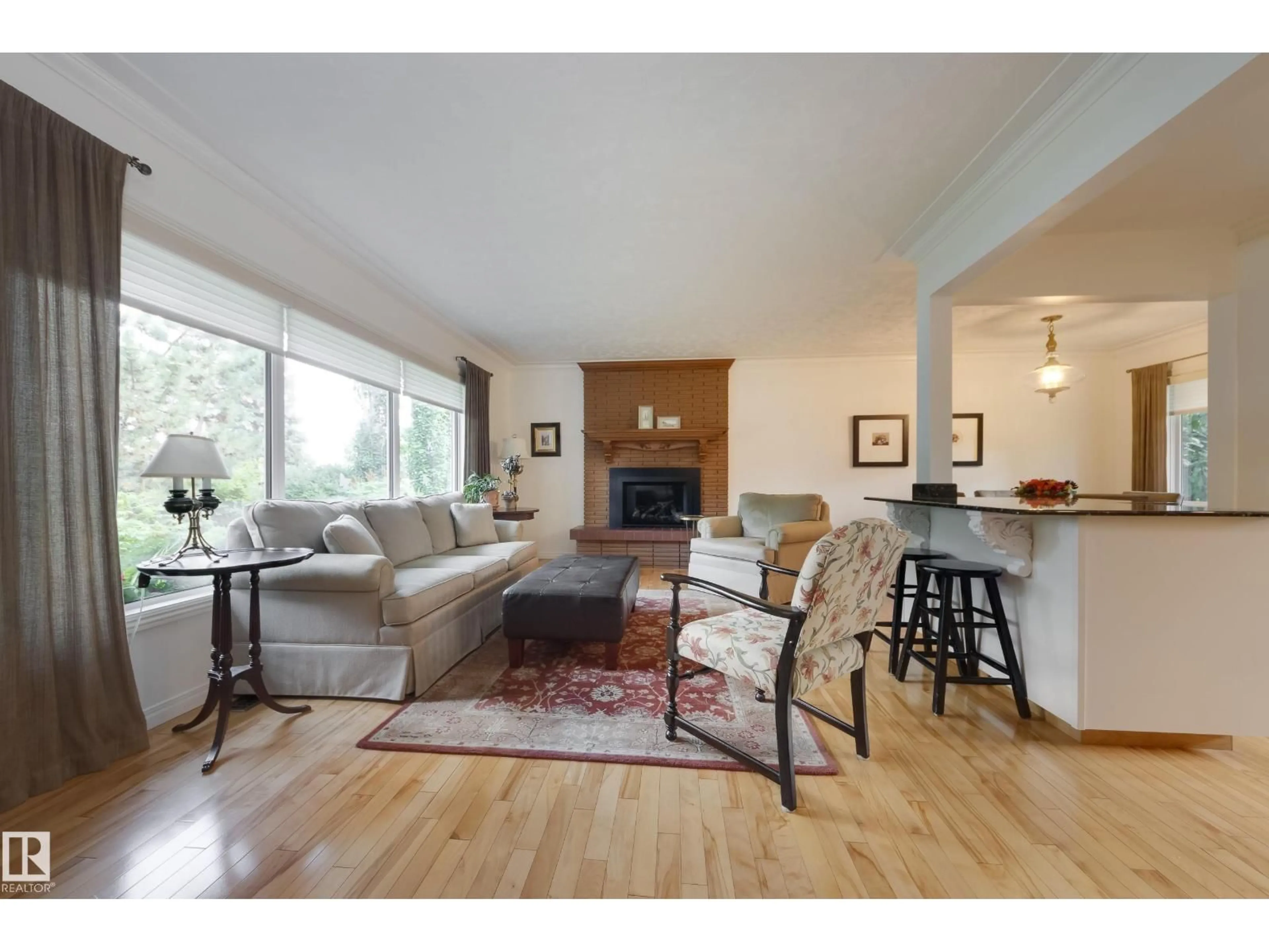 Living room with furniture, wood/laminate floor for NW - 4107 106B AV, Edmonton Alberta T6A1K7