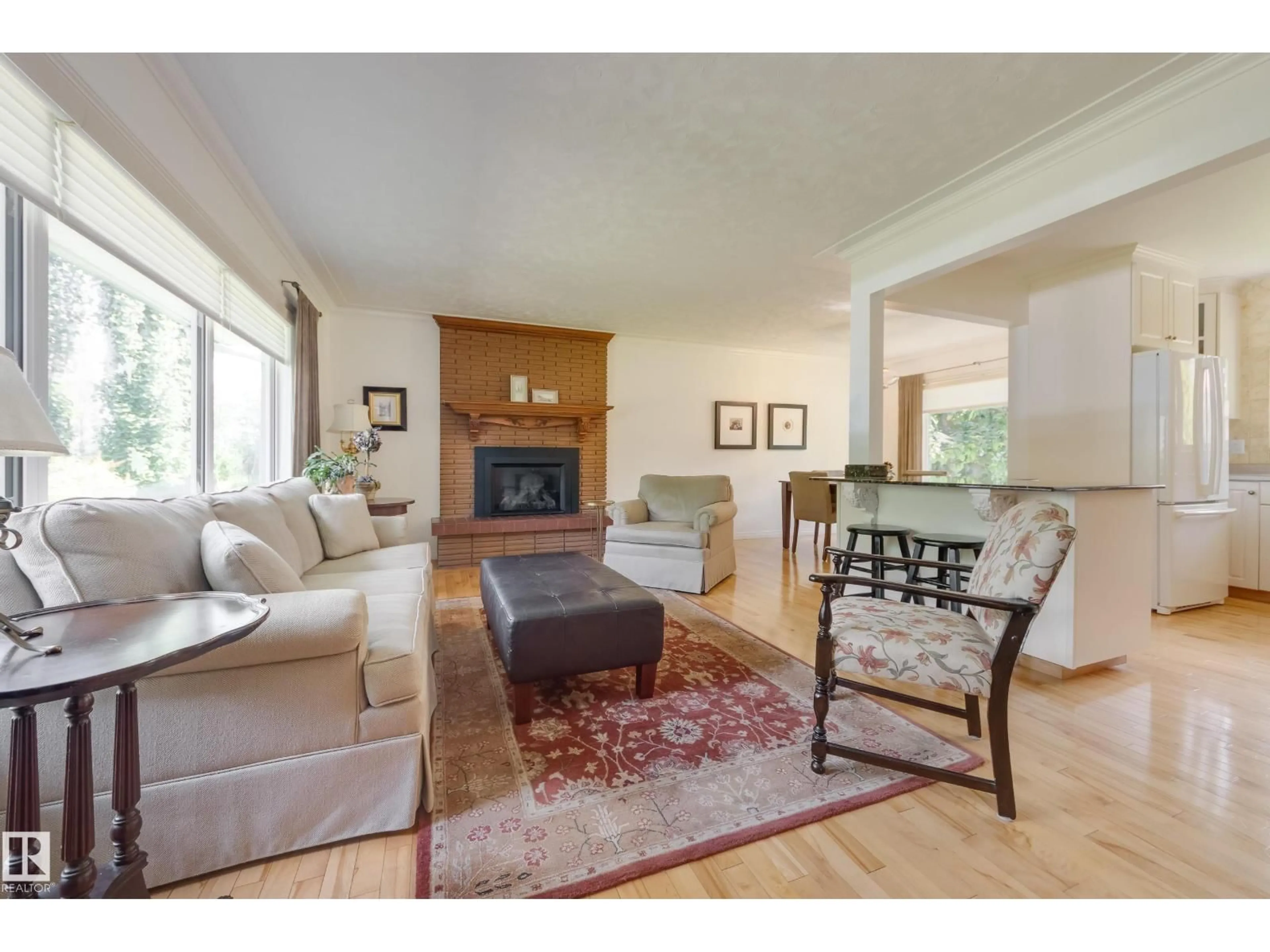 Living room with furniture, wood/laminate floor for NW - 4107 106B AV, Edmonton Alberta T6A1K7