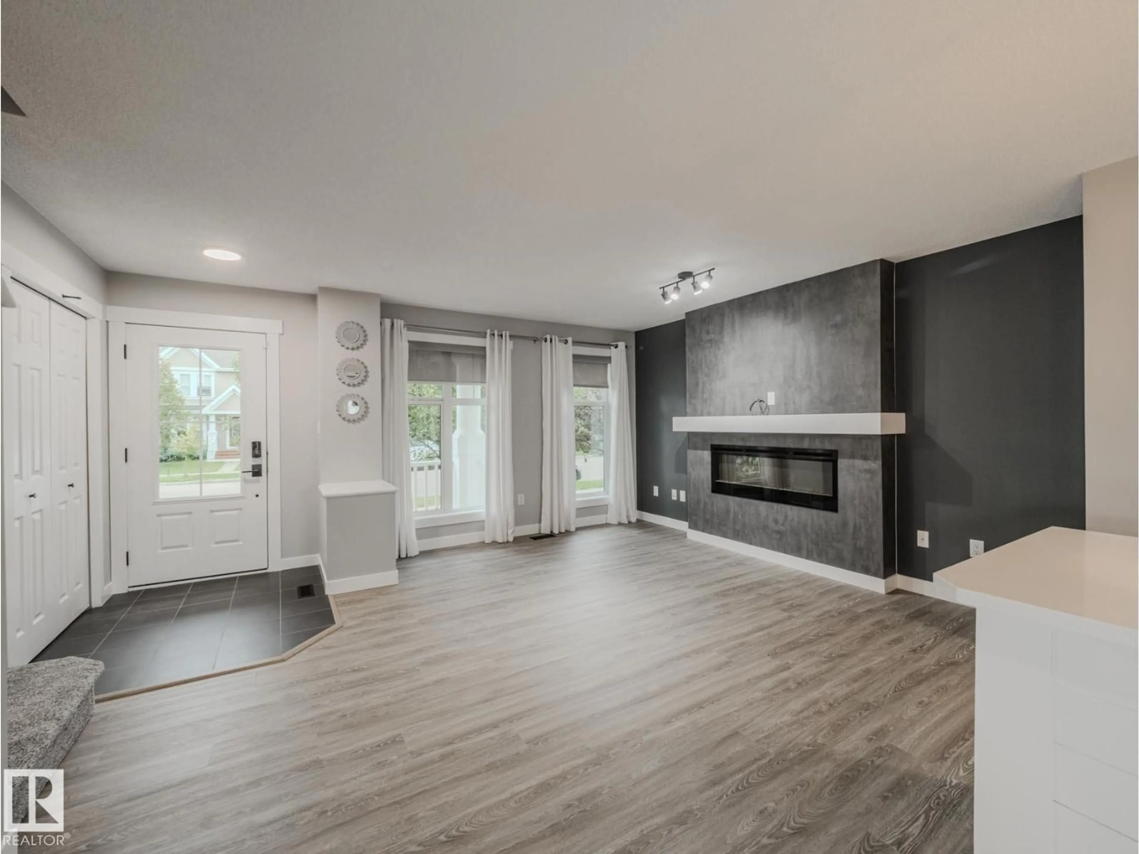 Living room with furniture, wood/laminate floor for 7311 22 AV, Edmonton Alberta T6X0V6
