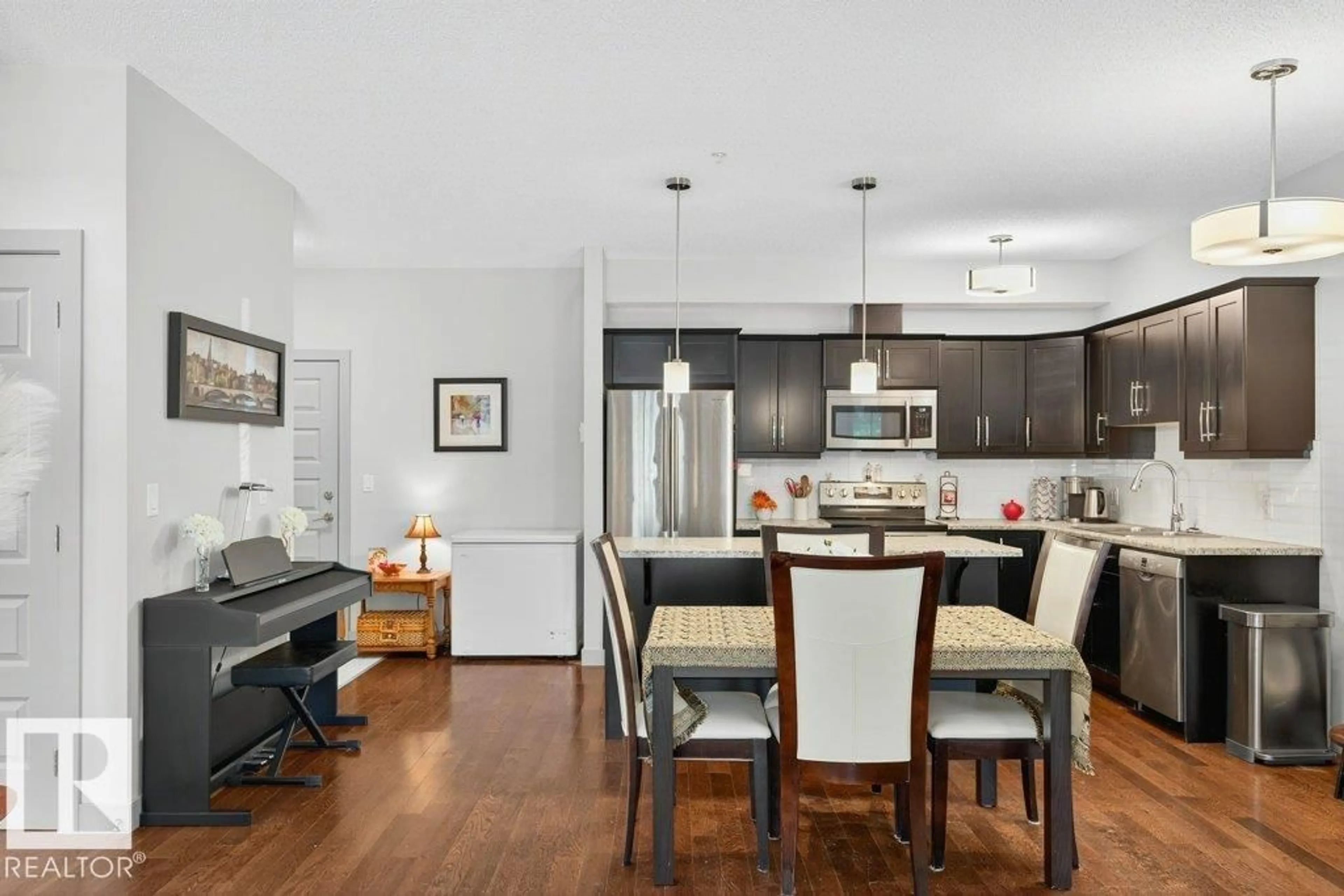Open concept kitchen, wood/laminate floor for 110 - 10520 56 AV, Edmonton Alberta T6H0X7
