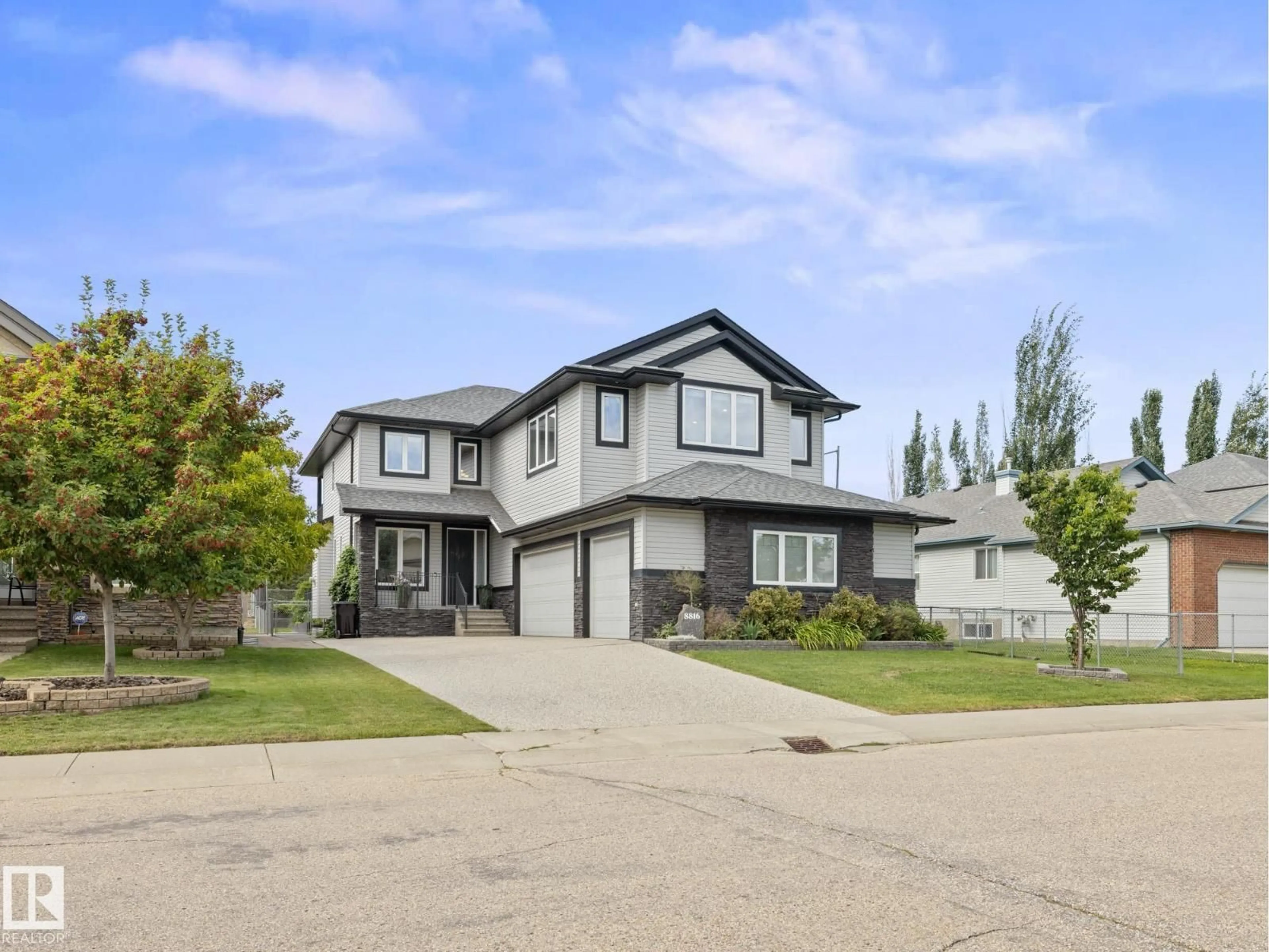 Home with vinyl exterior material, street for 8816 208 ST, Edmonton Alberta T5T6Y3