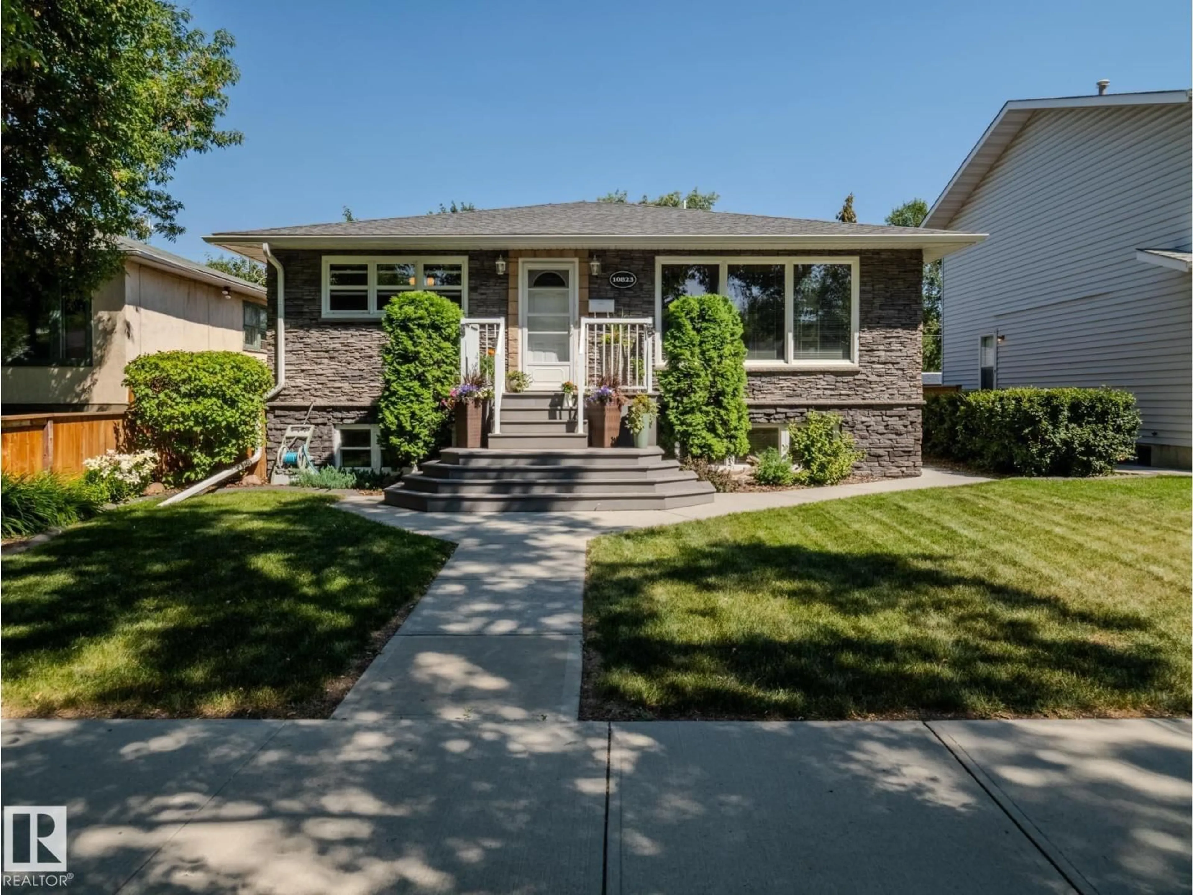 Home with vinyl exterior material, street for NW - 10823 122 ST, Edmonton Alberta T5M0A5