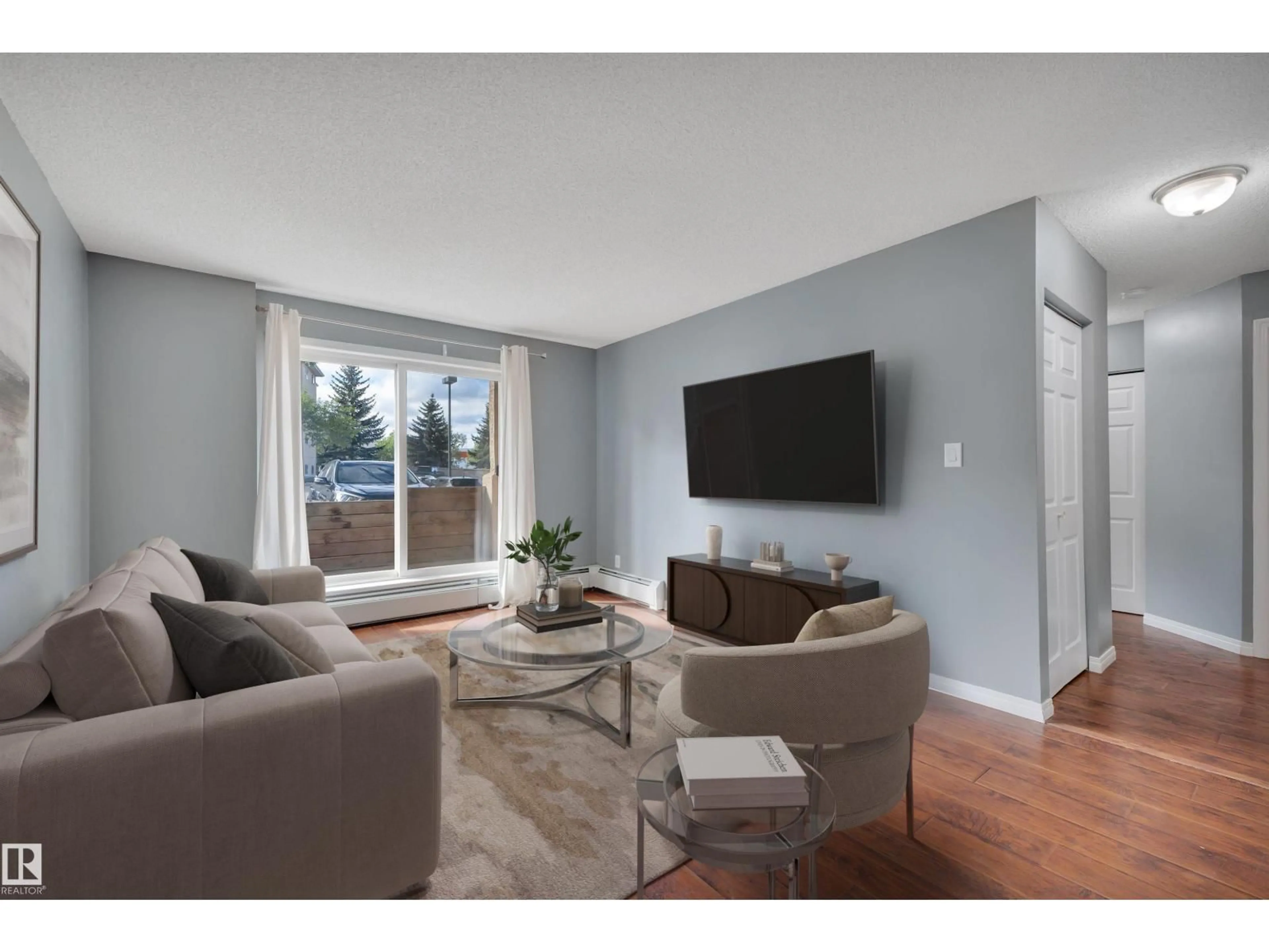 Living room with furniture, wood/laminate floor for 126 4210 139 AV NW, Edmonton Alberta T5Y2W6