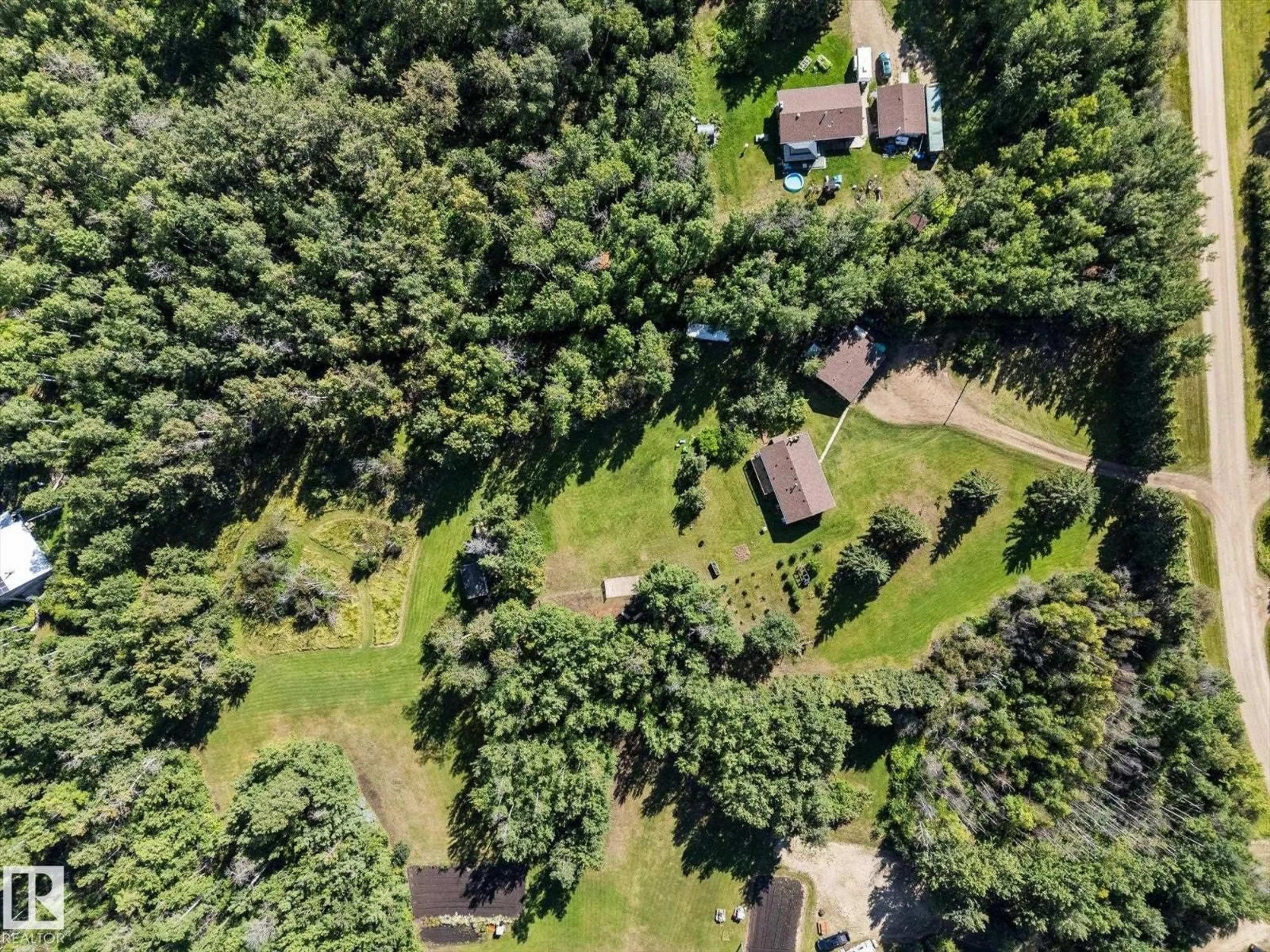 A pic from outside/outdoor area/front of a property/back of a property/a pic from drone, forest/trees view for 11A - 53301 RGE ROAD 32, Rural Parkland County Alberta T0E0N0