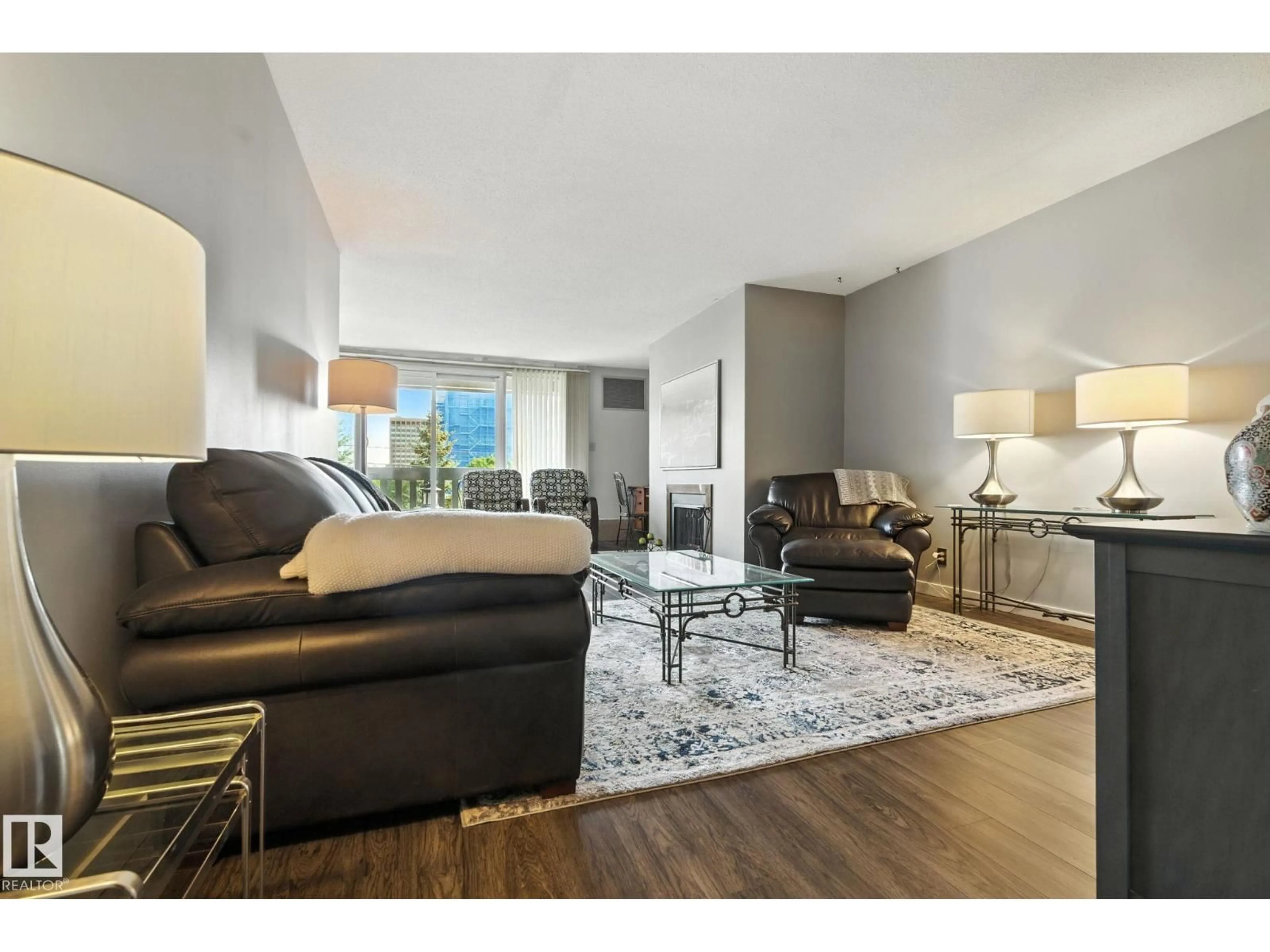 Living room with furniture, wood/laminate floor for 405 - 9809 110 ST, Edmonton Alberta T5K2J9