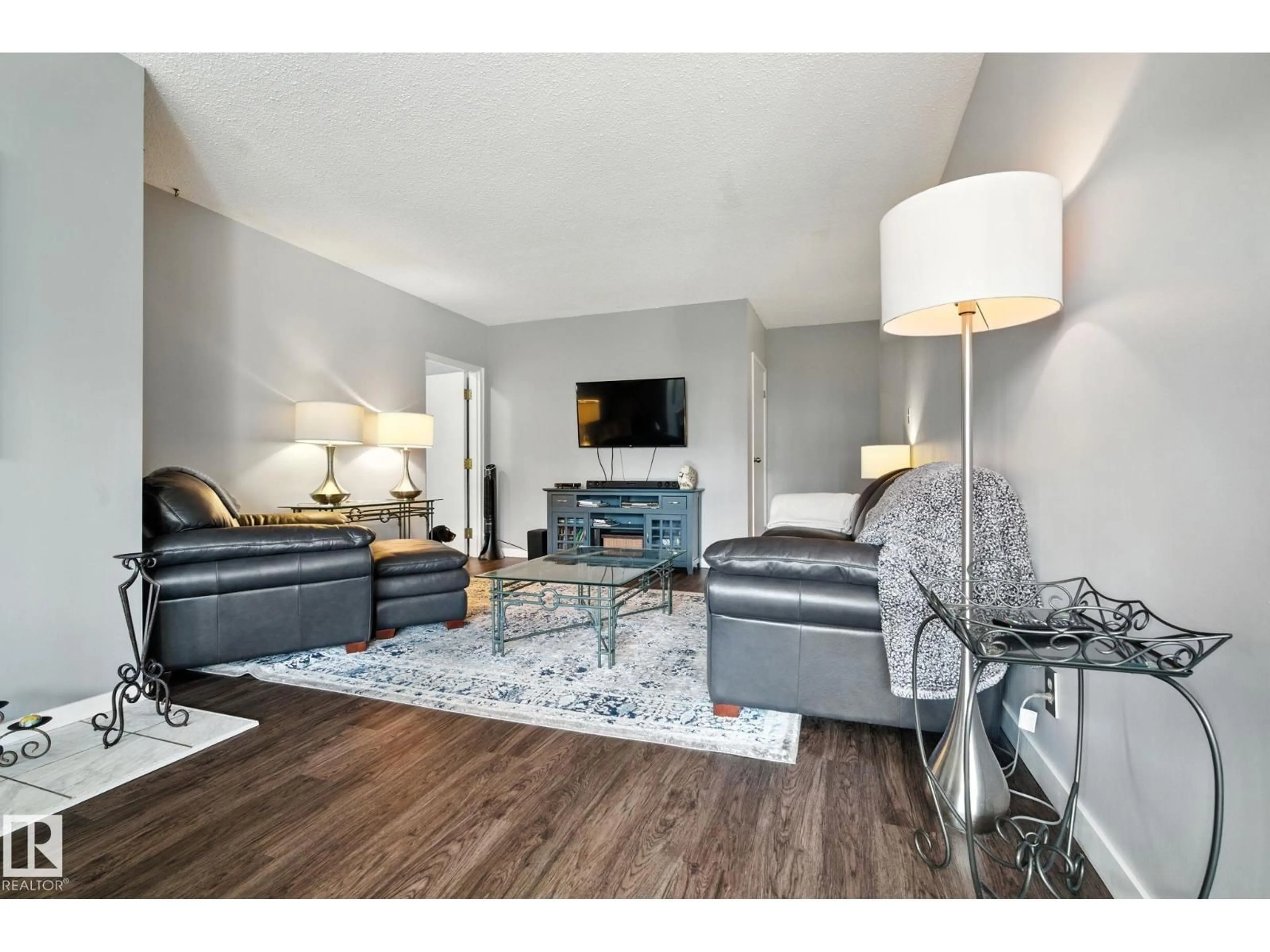 Living room with furniture, wood/laminate floor for 405 - 9809 110 ST, Edmonton Alberta T5K2J9
