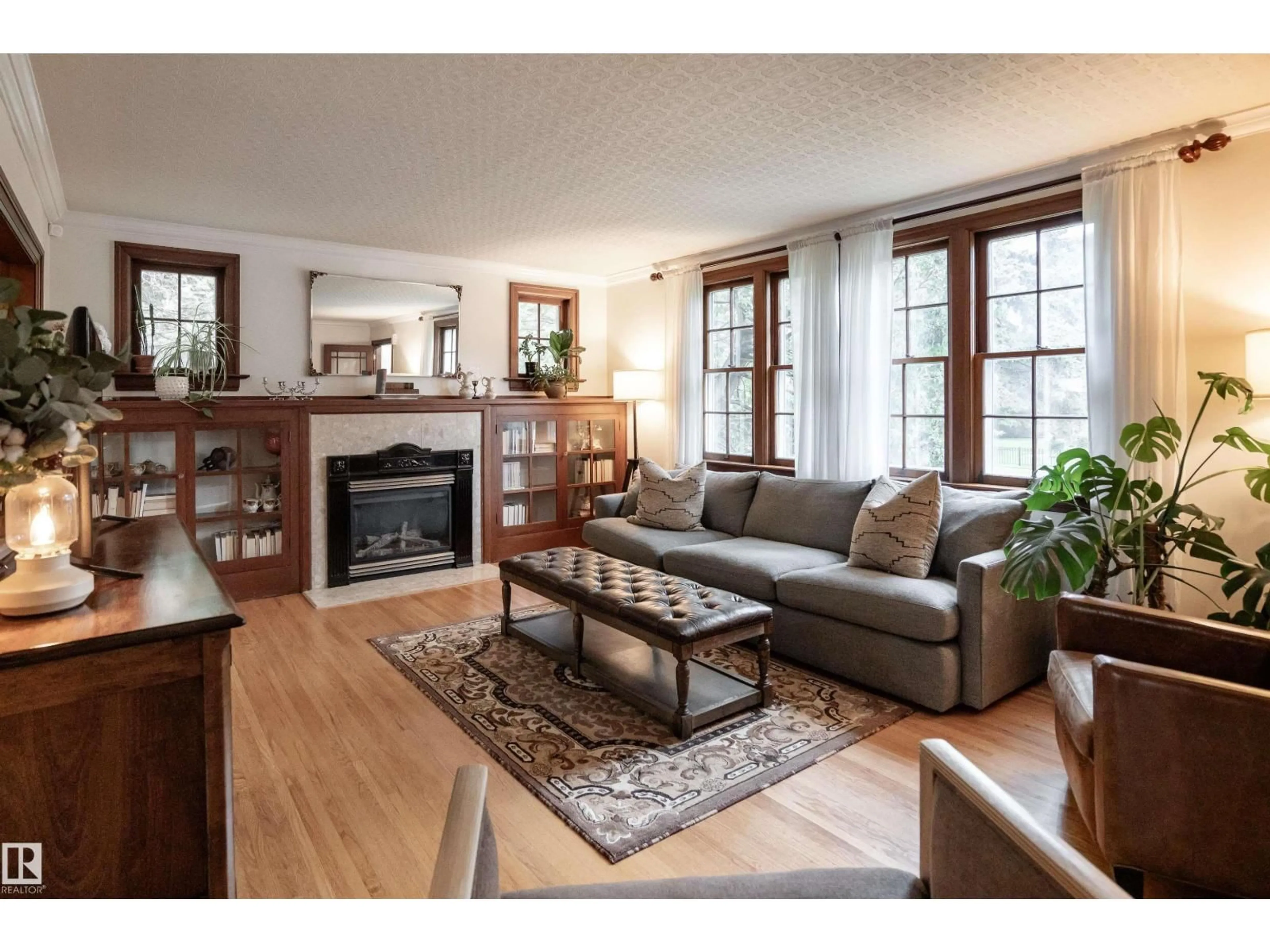 Living room with furniture, wood/laminate floor for 10015 97 AV, Edmonton Alberta T5K0A9