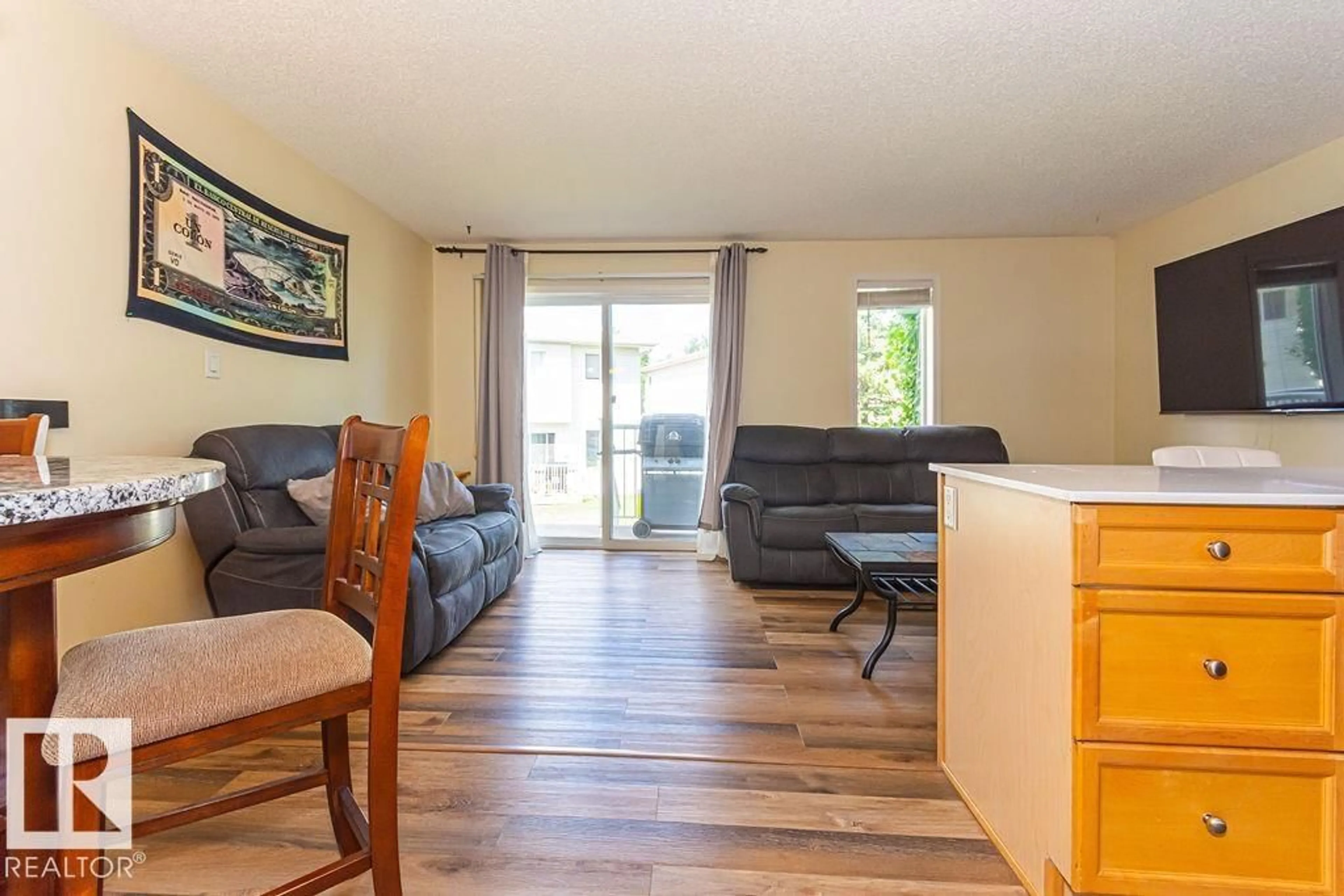 Living room with furniture, wood/laminate floor for 451 - 56 HYNDMAN CR, Edmonton Alberta T5A5J3