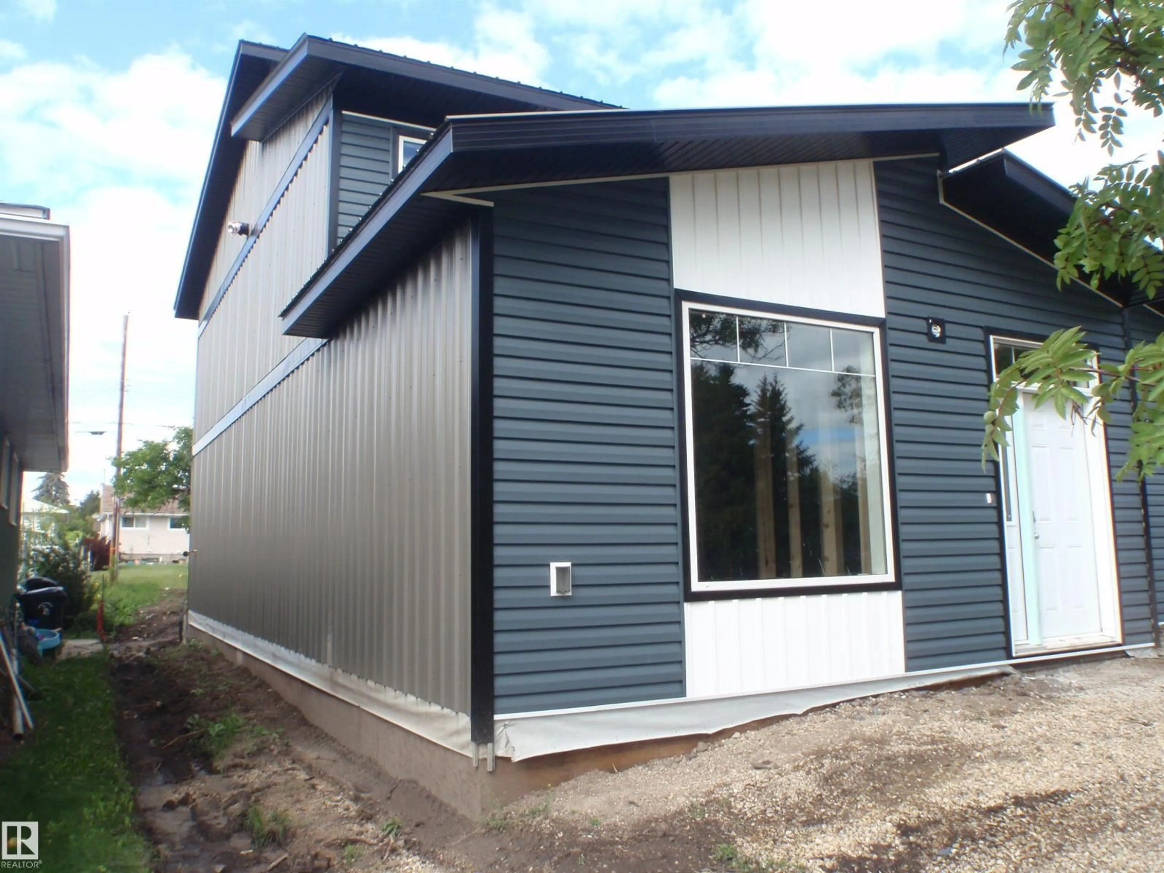 Home with vinyl exterior material, building for 4418 55 AV, Barrhead Alberta T7N1K1