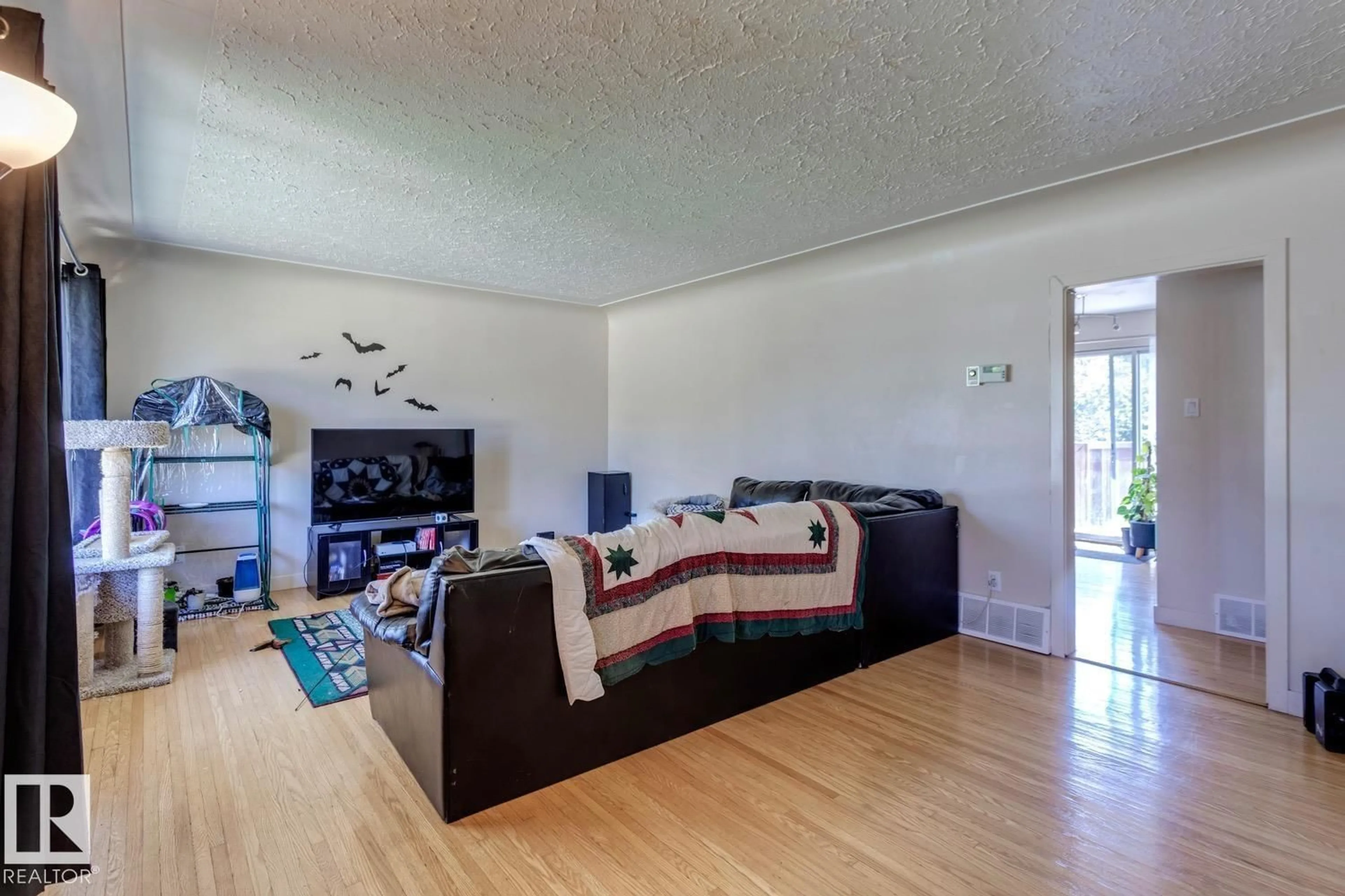 Living room with furniture, wood/laminate floor for 10915 60 AV, Edmonton Alberta T6E1H8
