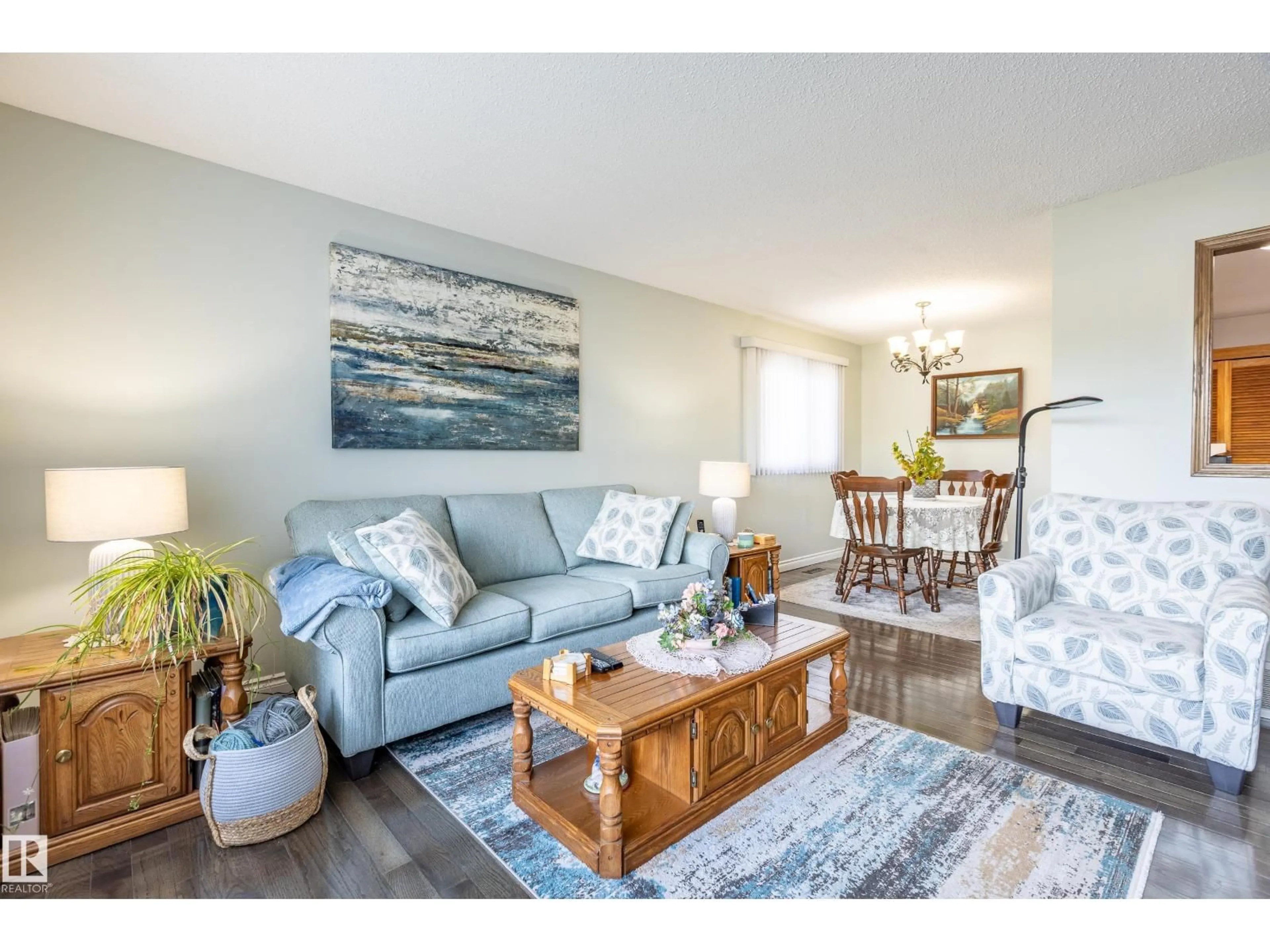 Living room with furniture, wood/laminate floor for 732 GRANDIN DR, Morinville Alberta T8R1K2