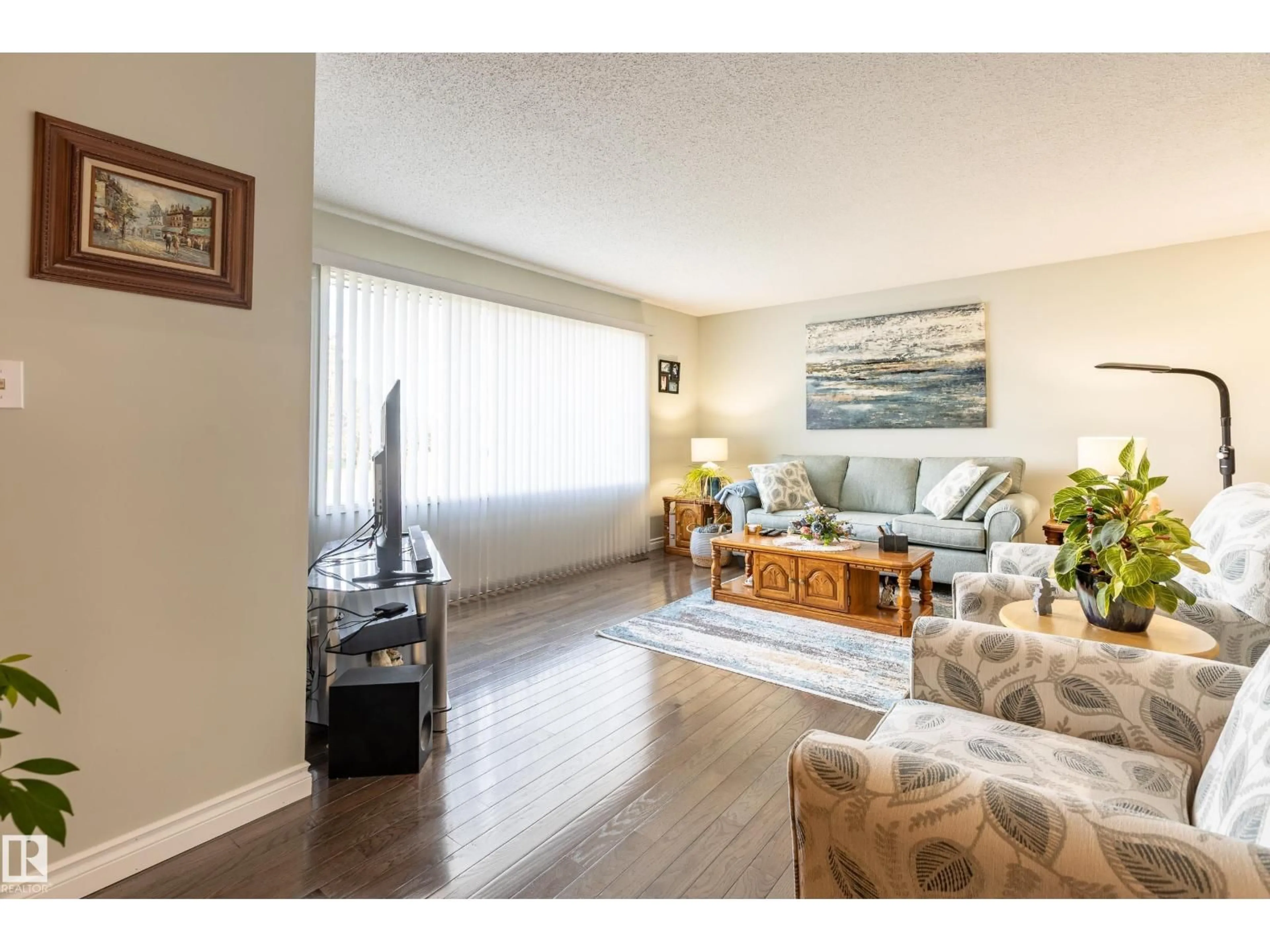 Living room with furniture, wood/laminate floor for 732 GRANDIN DR, Morinville Alberta T8R1K2
