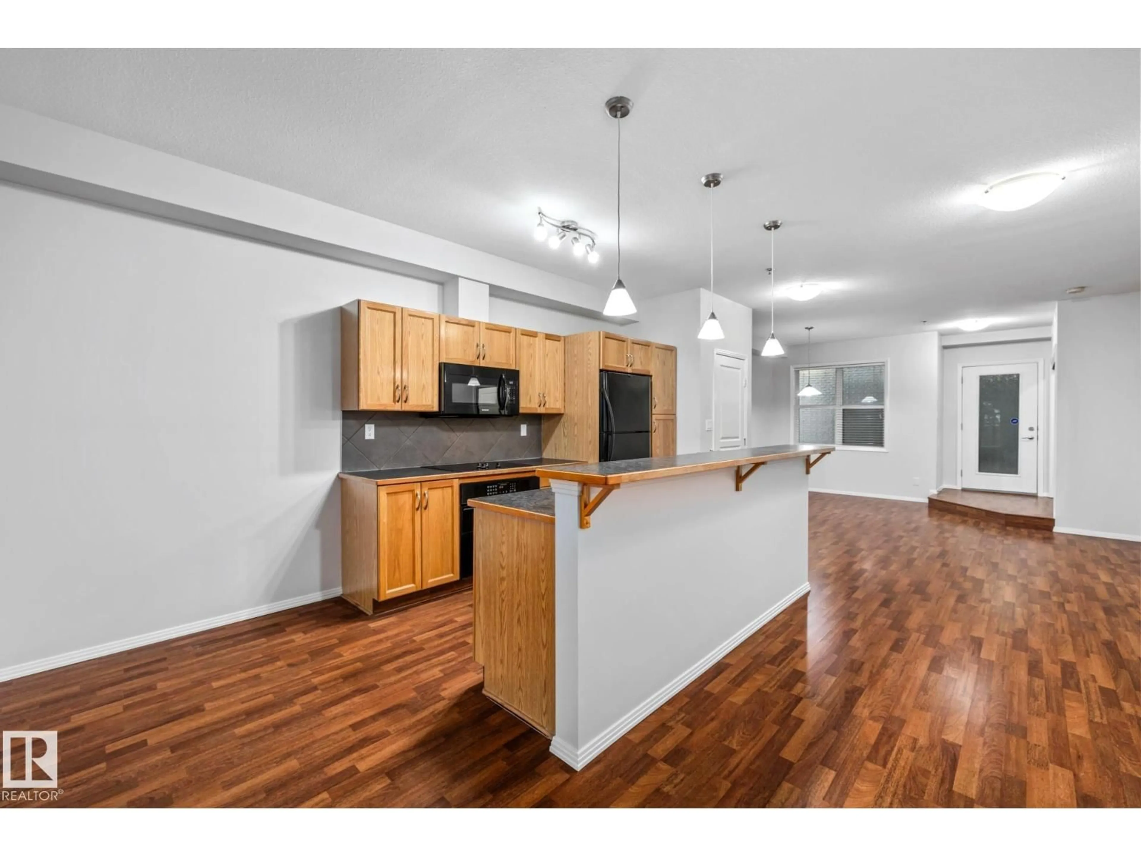Open concept kitchen, wood/laminate floor for #127 - 4831 104A ST, Edmonton Alberta T6H0R5