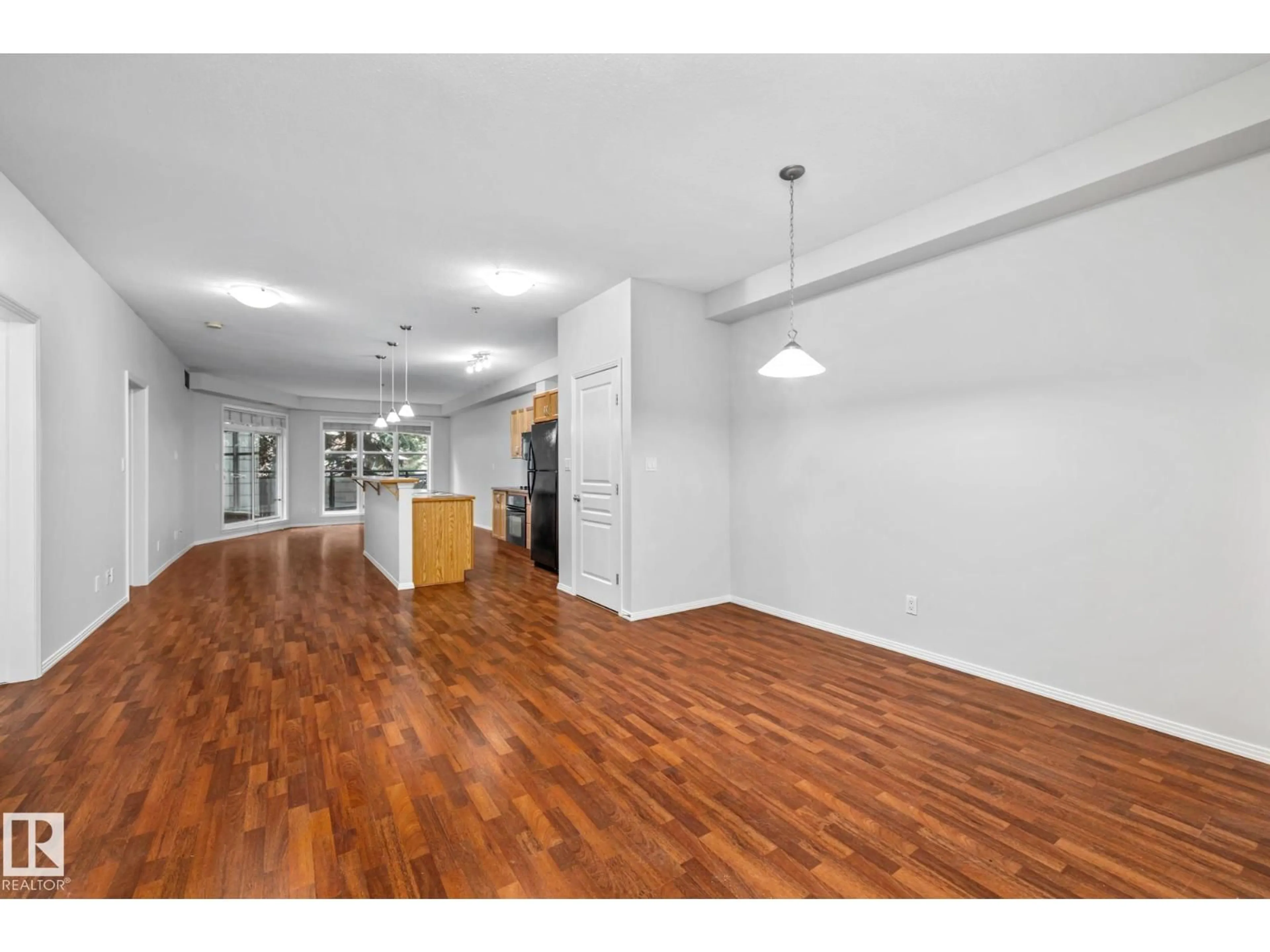 Open concept kitchen, wood/laminate floor for #127 - 4831 104A ST, Edmonton Alberta T6H0R5