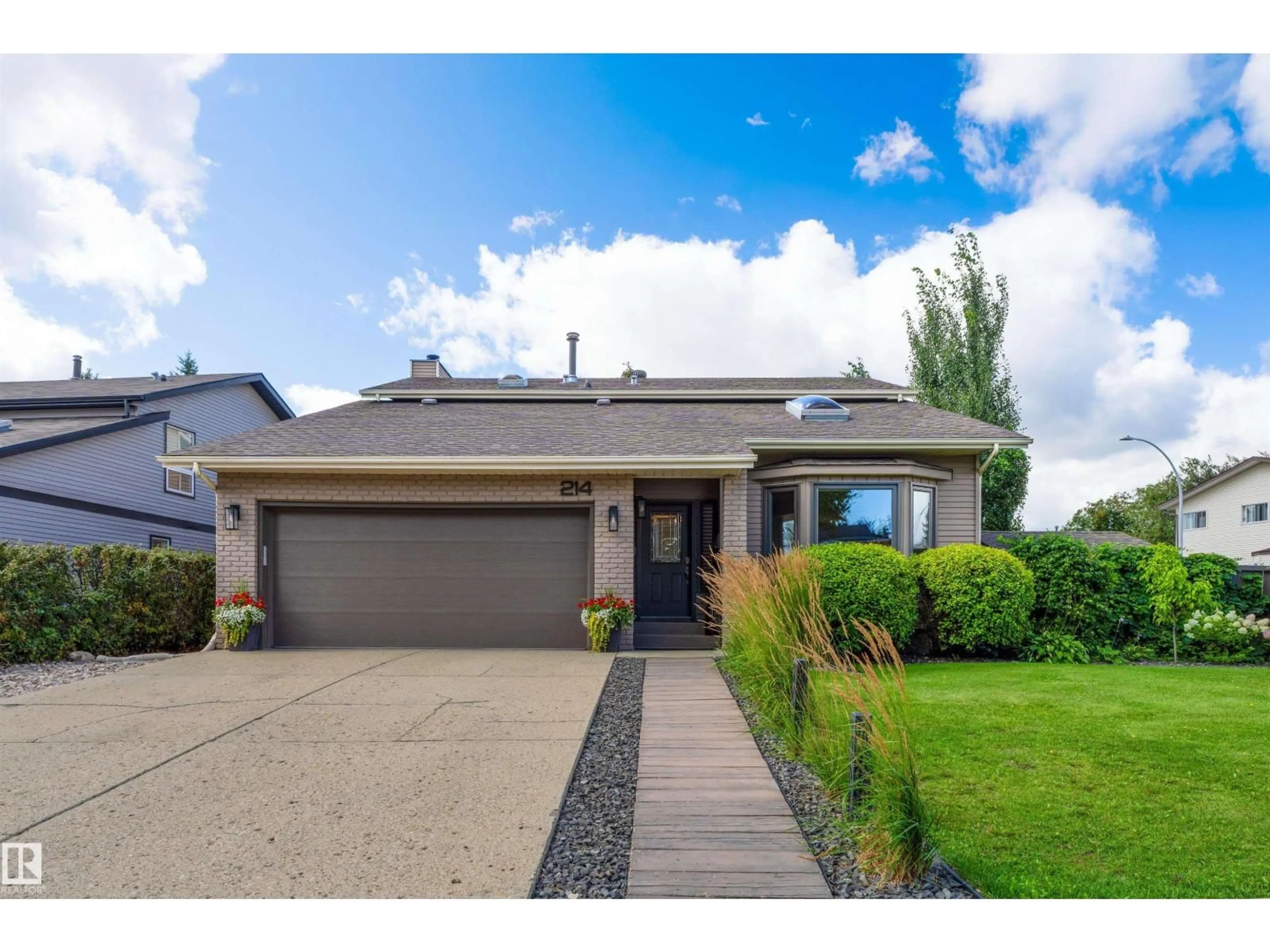Home with vinyl exterior material, street for 214 RHATIGAN RD W, Edmonton Alberta T6R1G1
