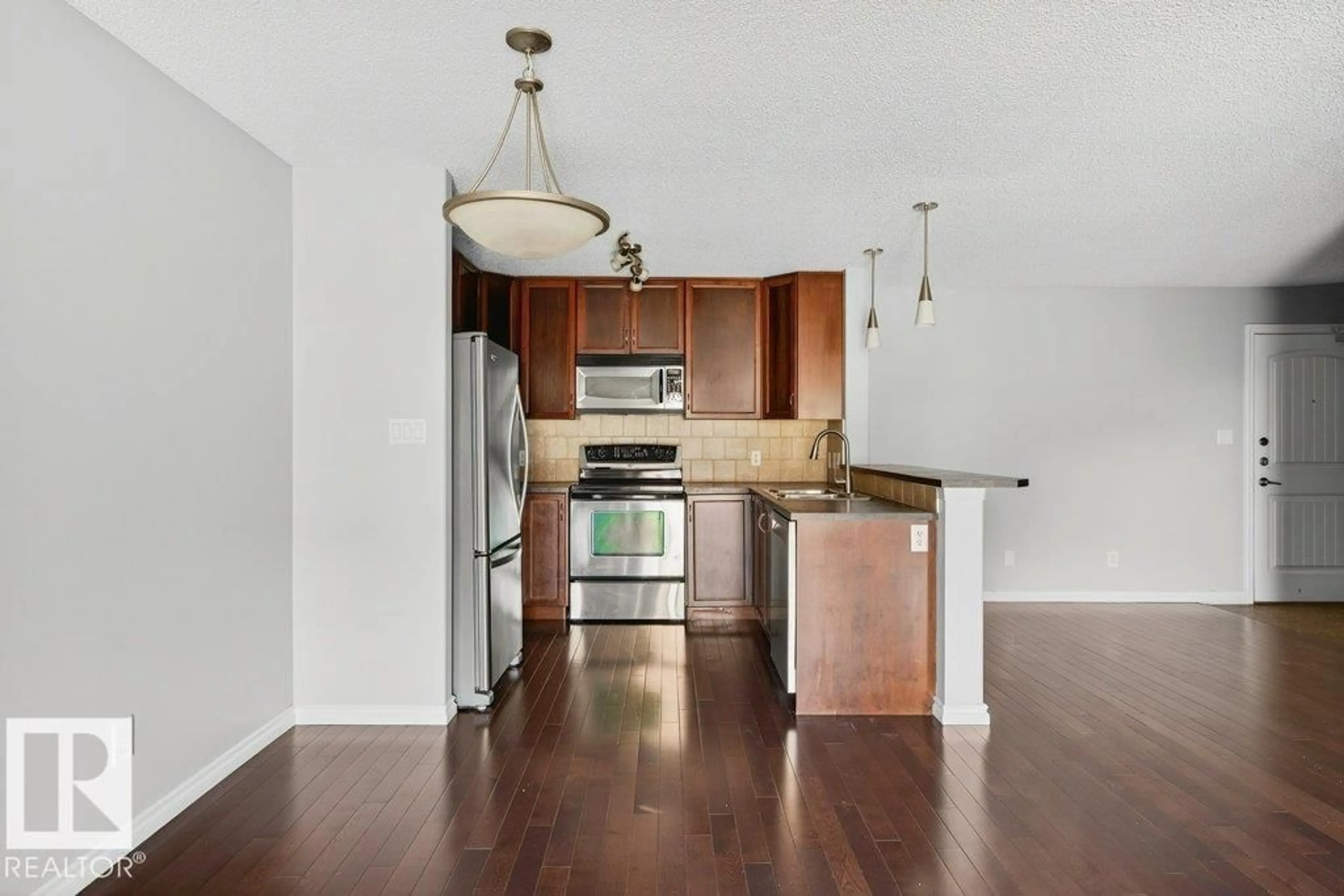 Open concept kitchen, wood/laminate floor for 321 17415 99 AV, Edmonton Alberta T5T0W8