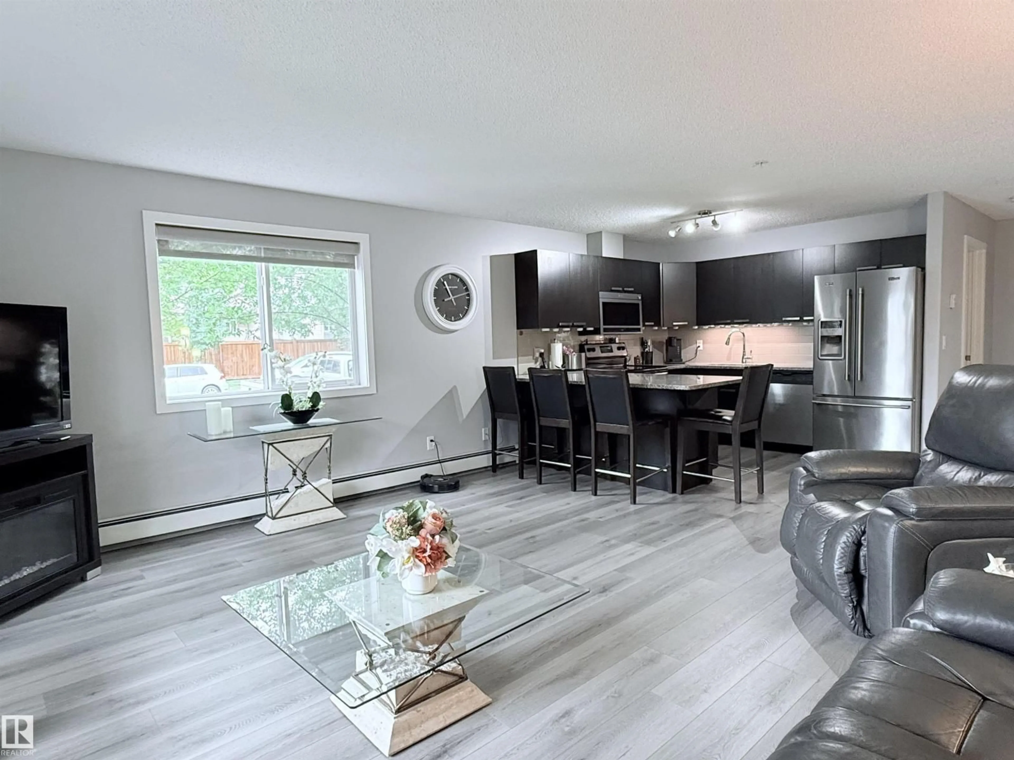 Open concept kitchen, wood/laminate floor for #104 - 14808 125 ST NW, Edmonton Alberta T5X0G1