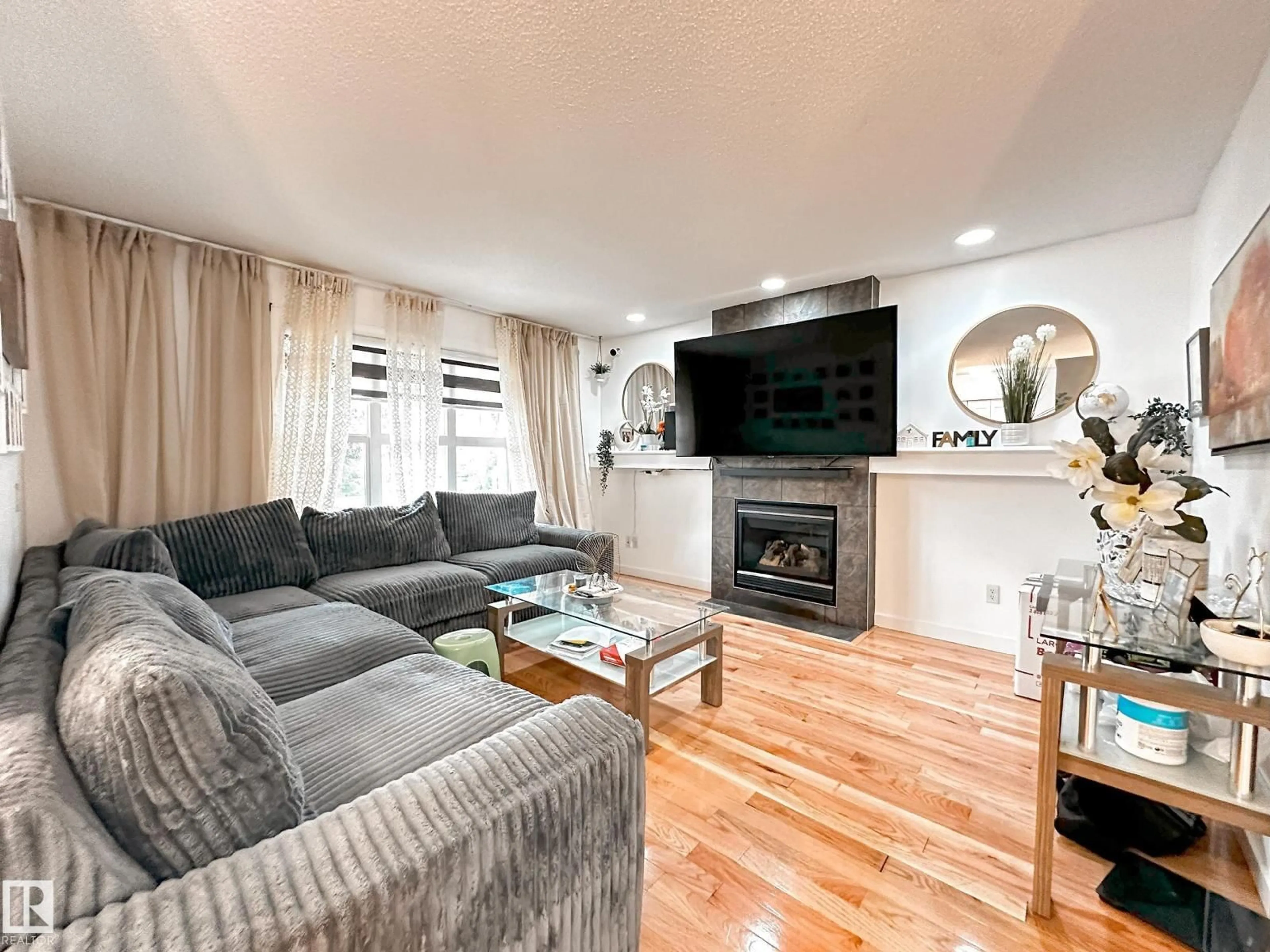 Living room with furniture, wood/laminate floor for SW - 223 61 ST, Edmonton Alberta T6X0E6