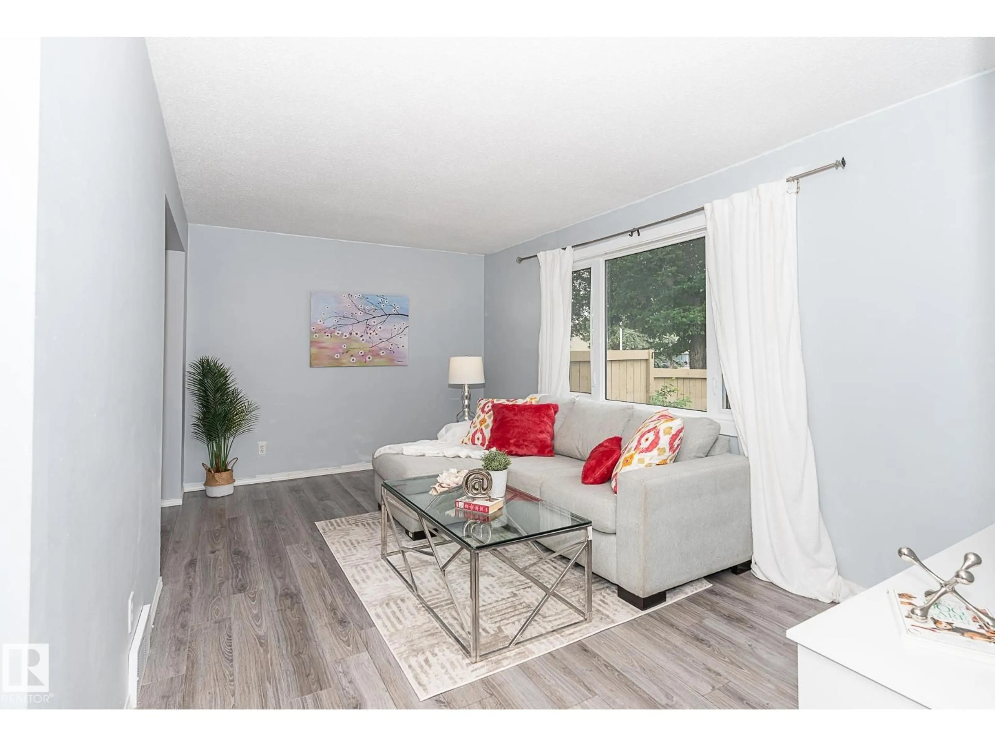 Living room with furniture, wood/laminate floor for #4 - 8010 141 AV, Edmonton Alberta T5C2N9