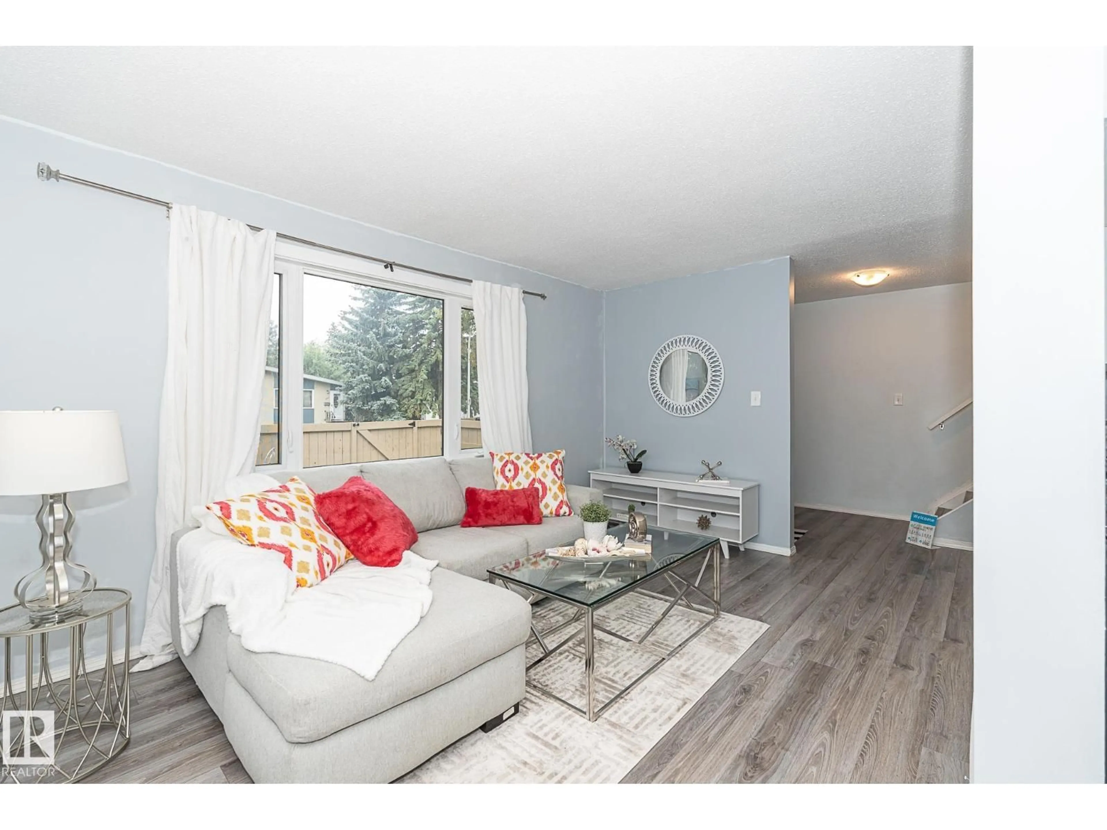 Living room with furniture, wood/laminate floor for #4 - 8010 141 AV, Edmonton Alberta T5C2N9