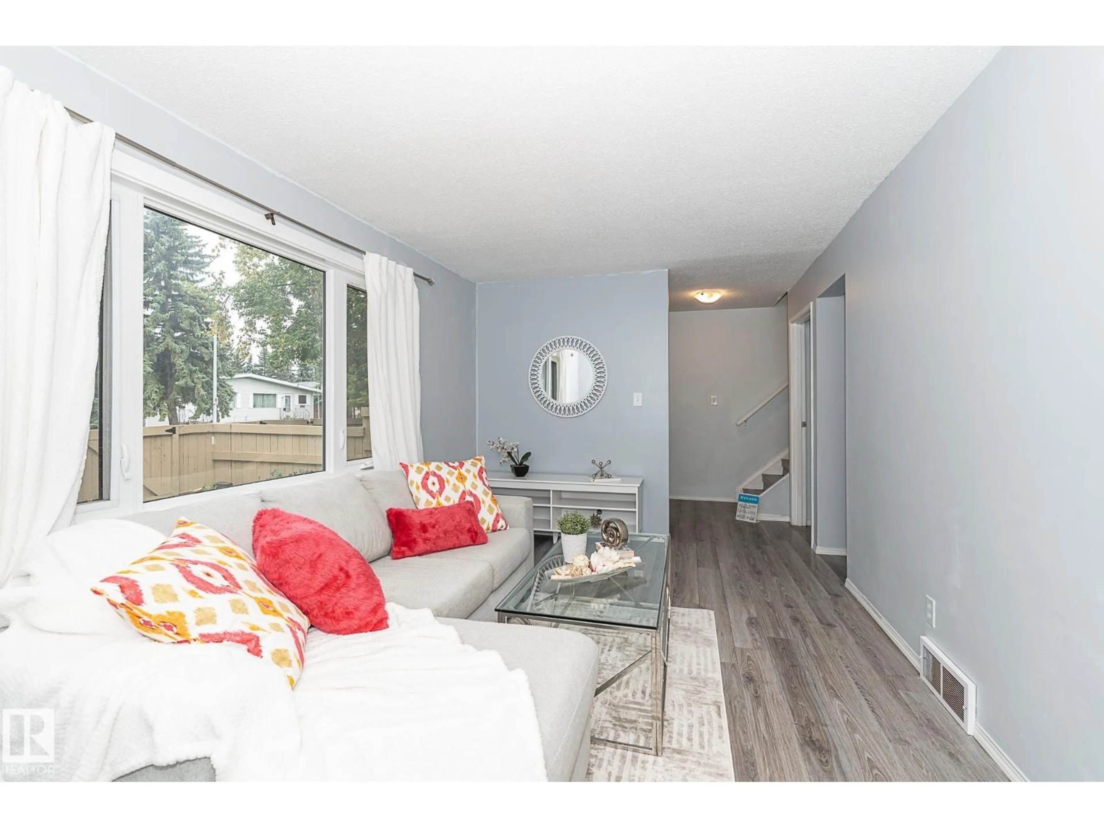 Living room with furniture, wood/laminate floor for #4 - 8010 141 AV, Edmonton Alberta T5C2N9