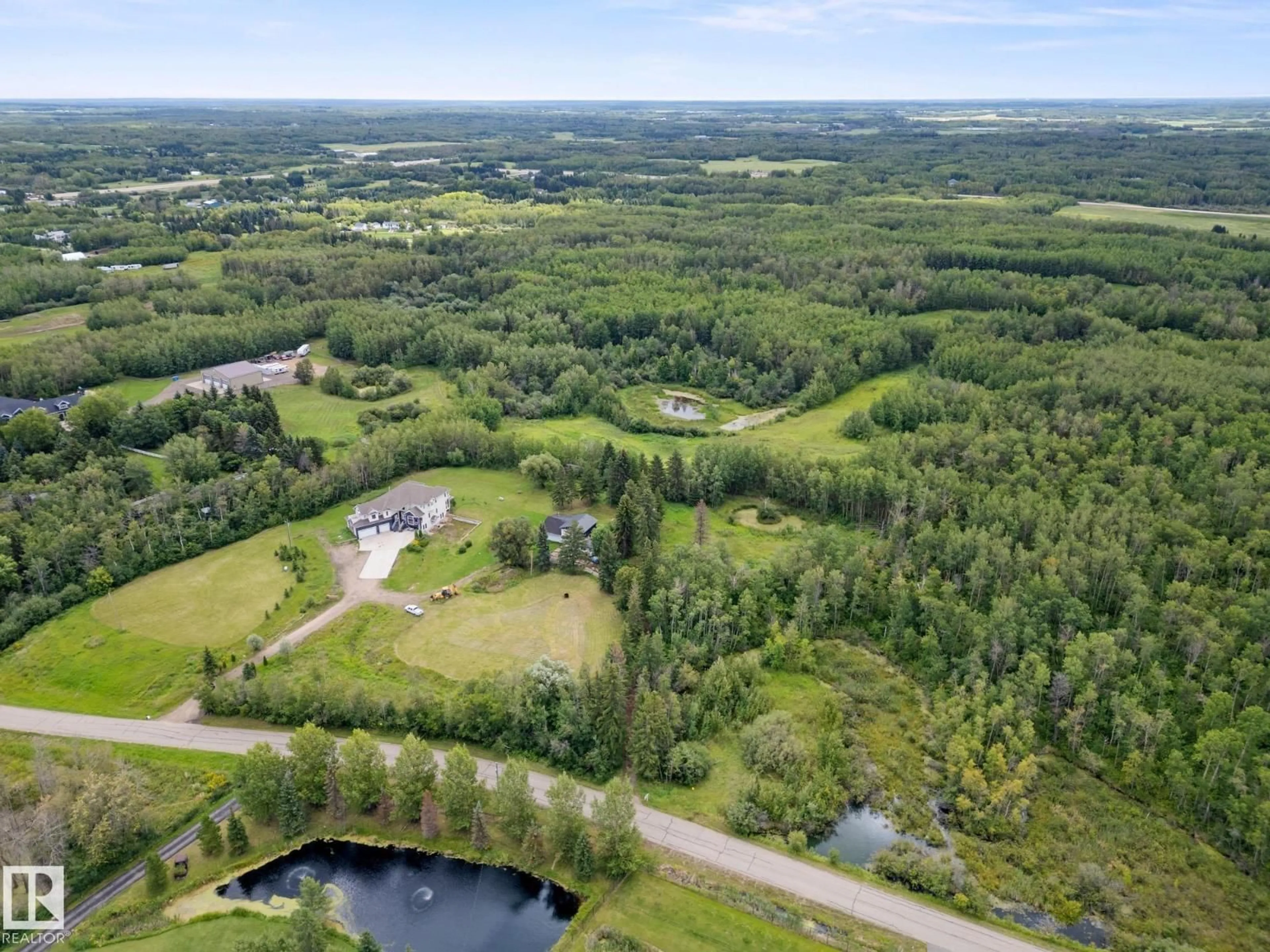 A pic from outside/outdoor area/front of a property/back of a property/a pic from drone, water/lake/river/ocean view for 52257 - 61 RGE ROAD 231, Rural Strathcona County Alberta T8B1A7