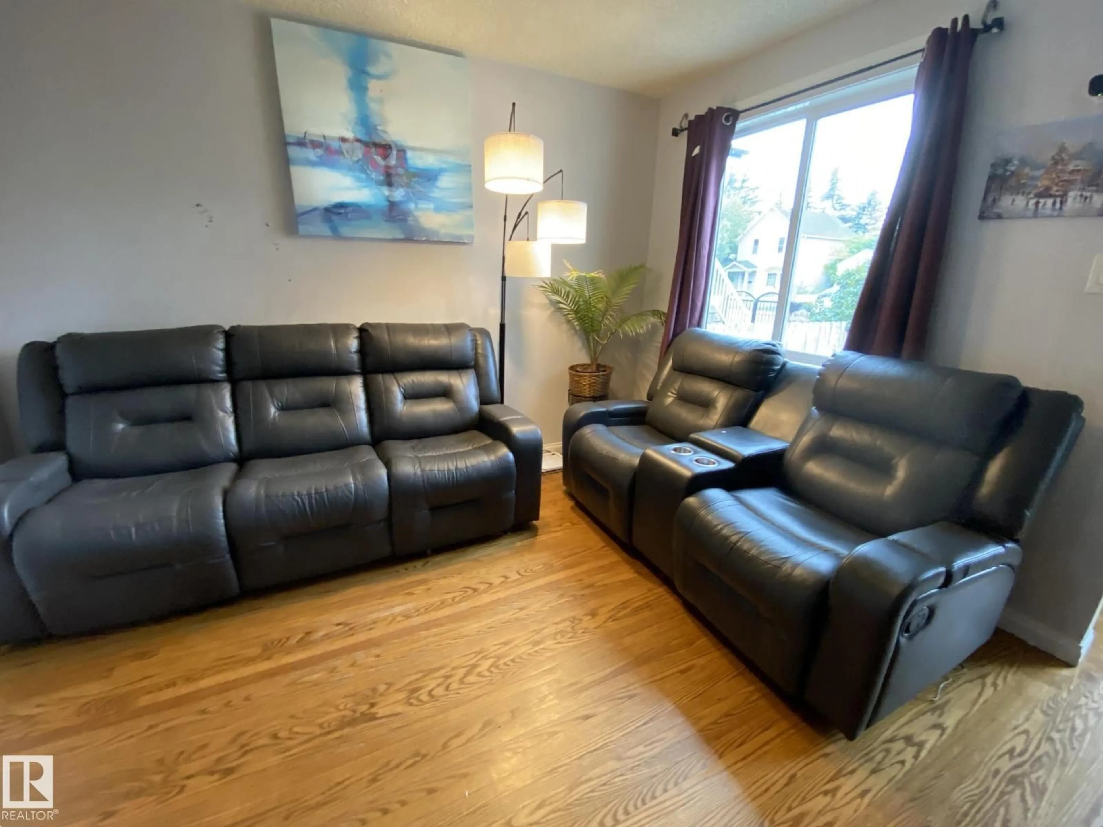 Living room with furniture, wood/laminate floor for 11447 95 ST, Edmonton Alberta T5G1L3