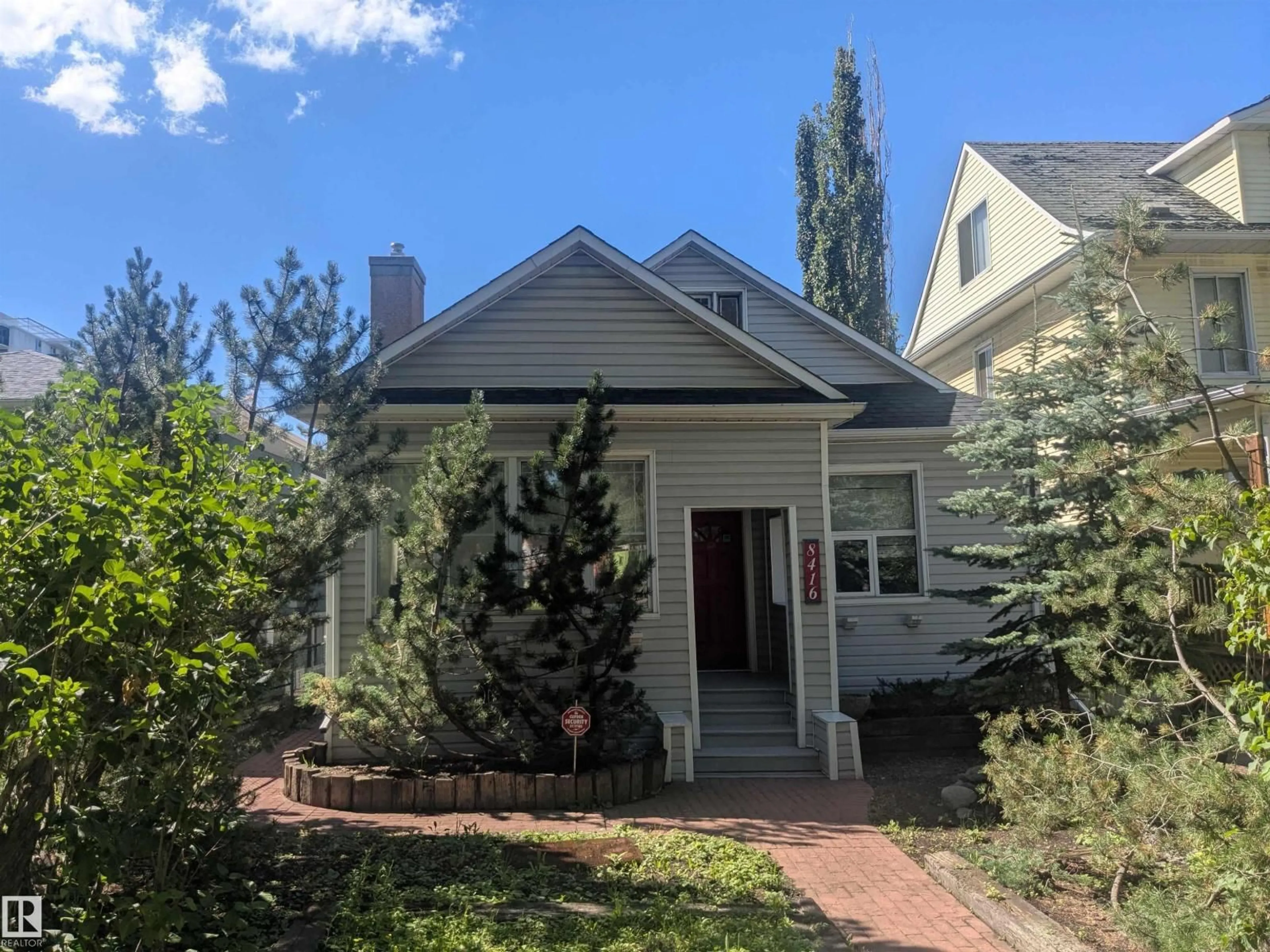 Home with vinyl exterior material, street for 8416 104 ST, Edmonton Alberta T6E4G2