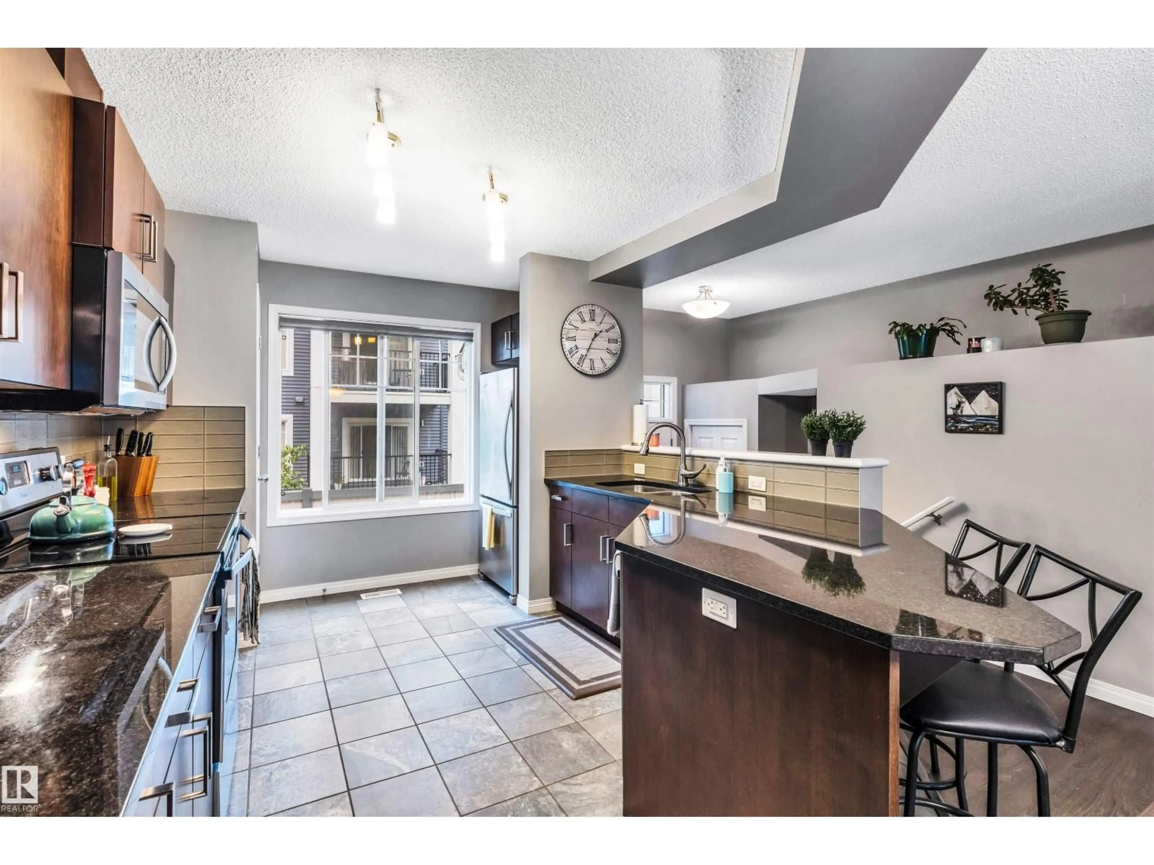 Open concept kitchen, ceramic/tile floor for 4050 - 19 SAVARYN DR, Edmonton Alberta T6X1R8
