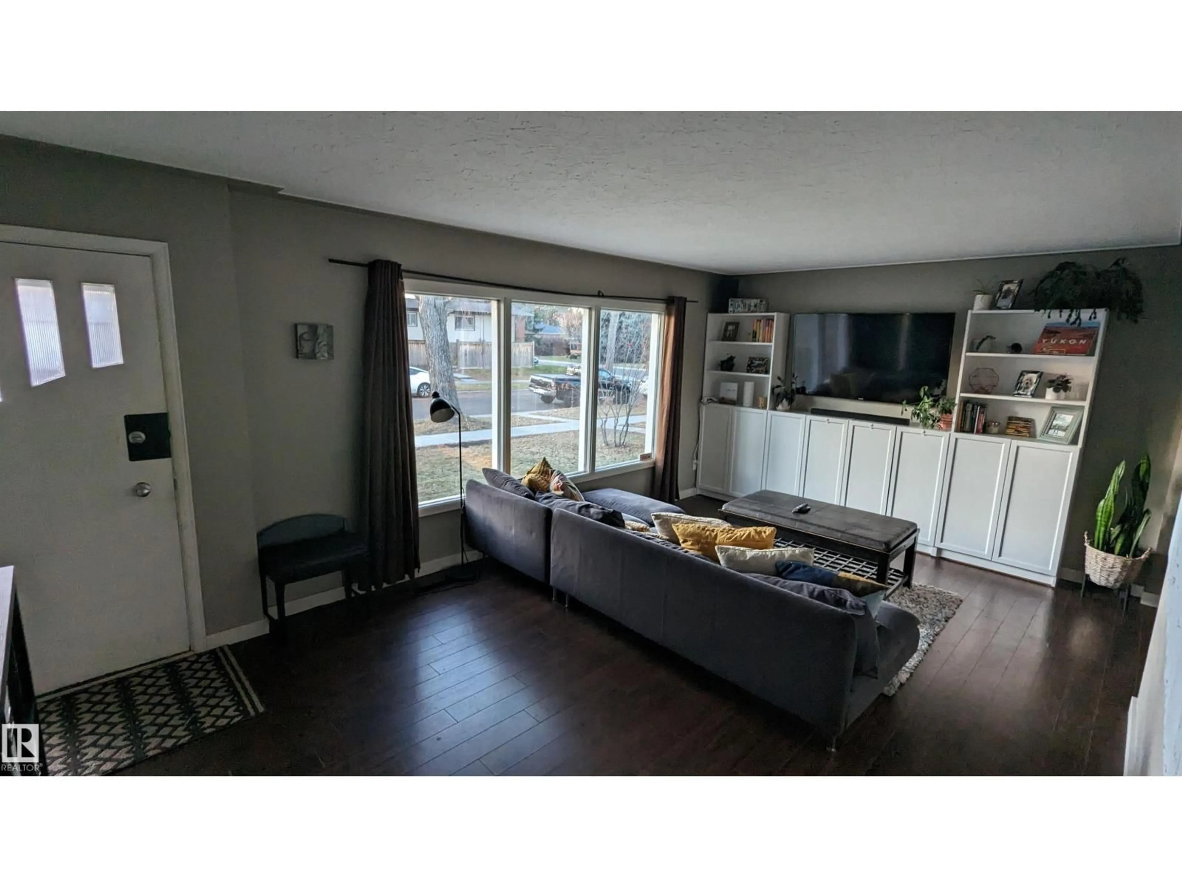 Living room with furniture, wood/laminate floor for NW - 6519 104A ST, Edmonton Alberta T6H2M2