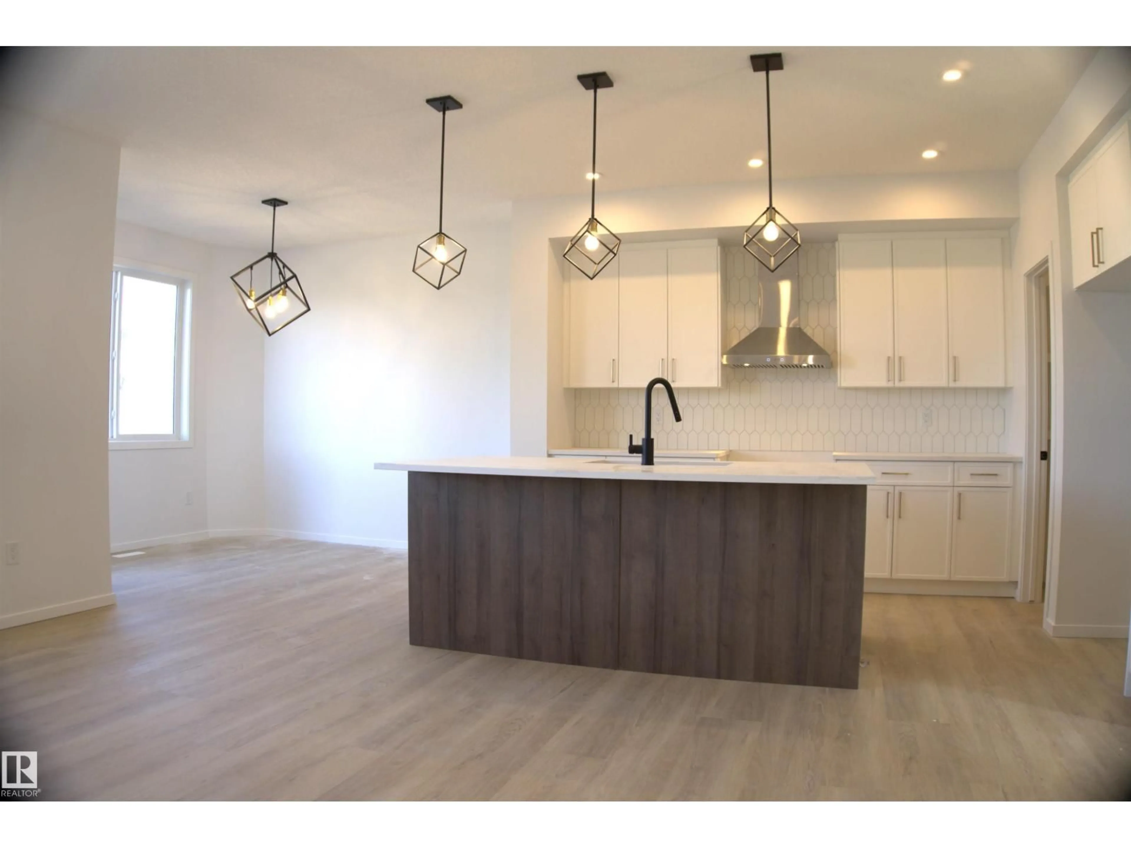 Open concept kitchen, wood/laminate floor for 7722 174A AV, Edmonton Alberta T5Z0W5
