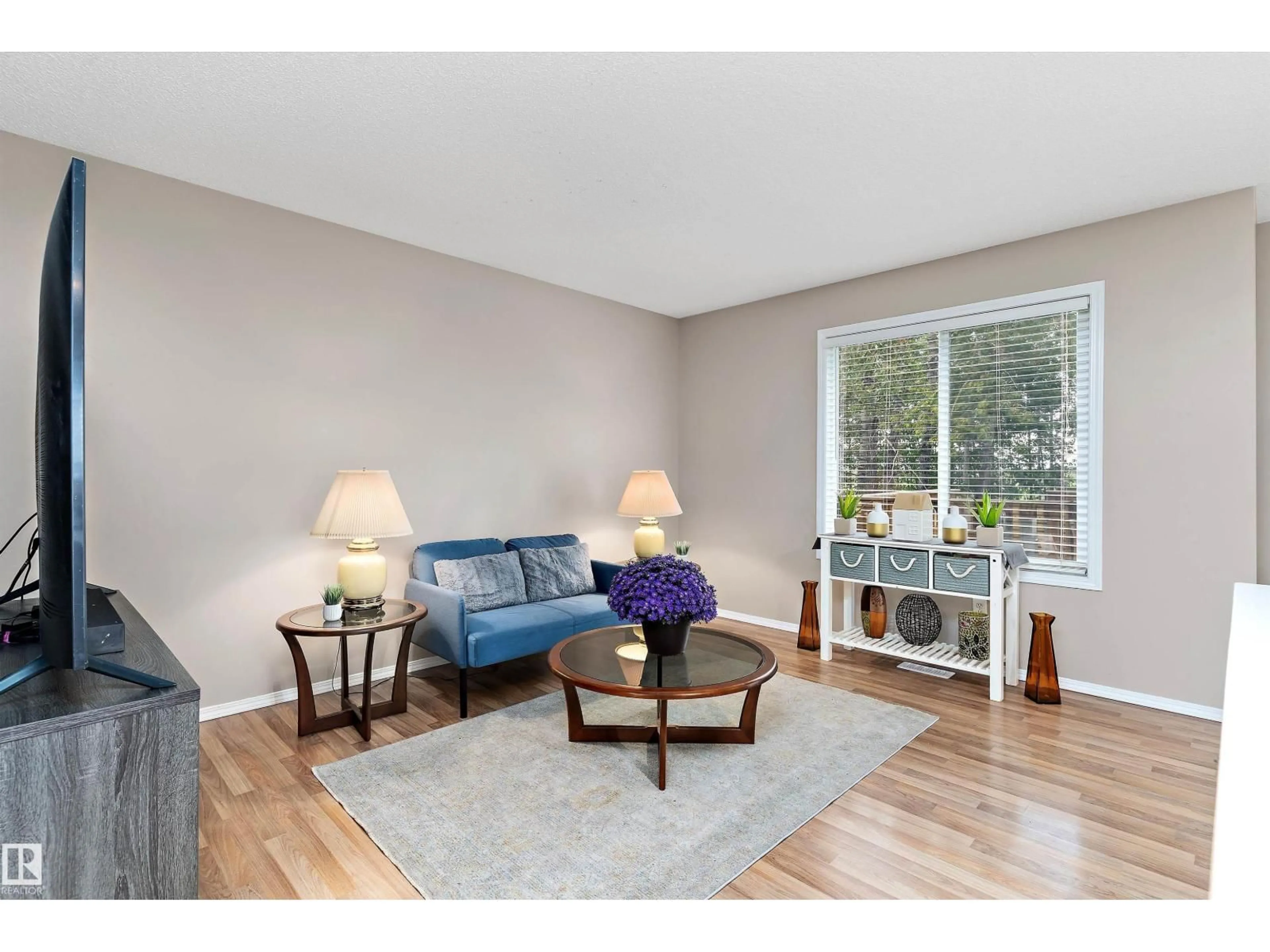 Living room with furniture, wood/laminate floor for SW - 6232 1A AV, Edmonton Alberta T6X0C1