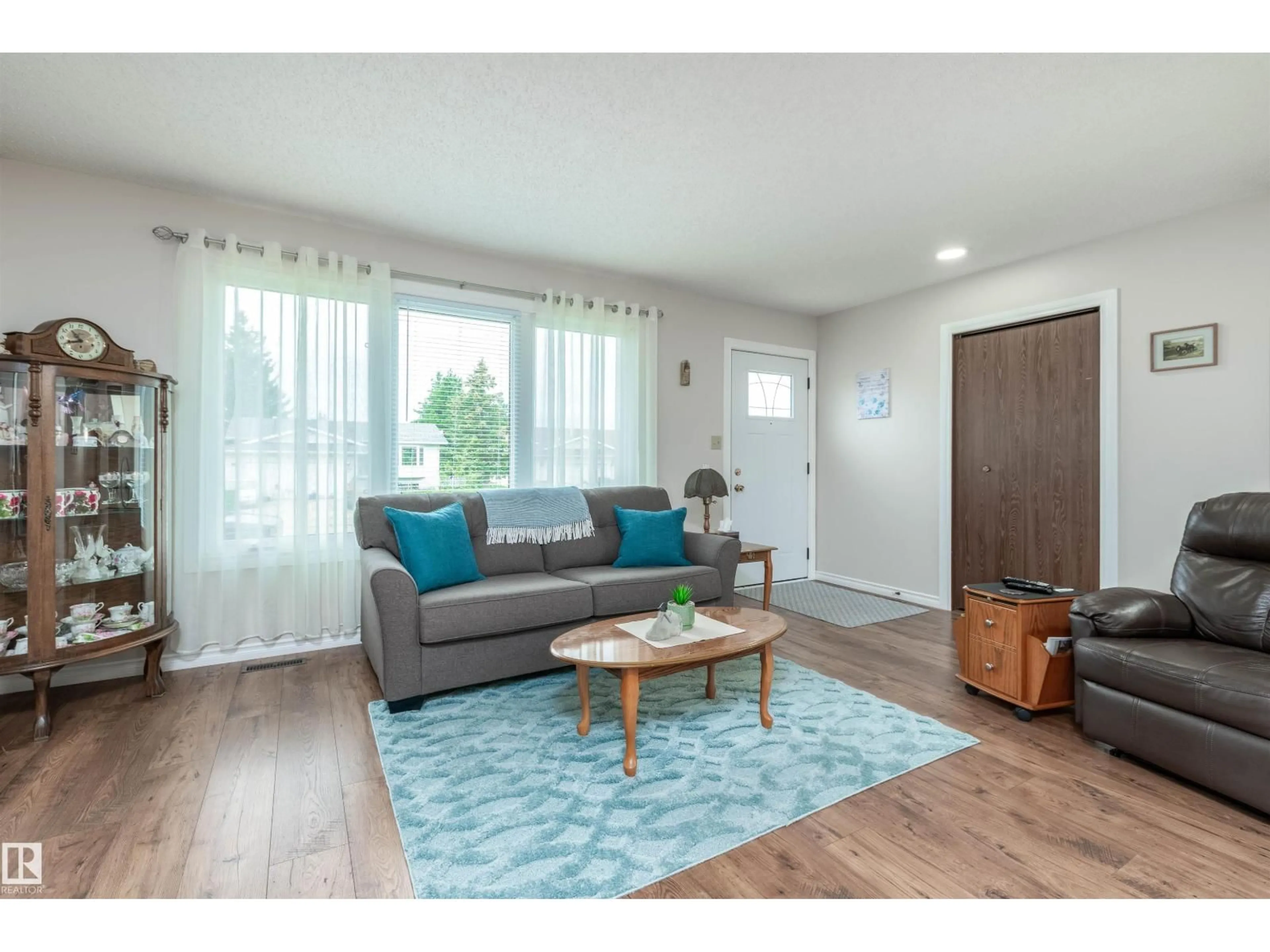 Living room with furniture, wood/laminate floor for 5214 45 ST, Tofield Alberta T0B0S0