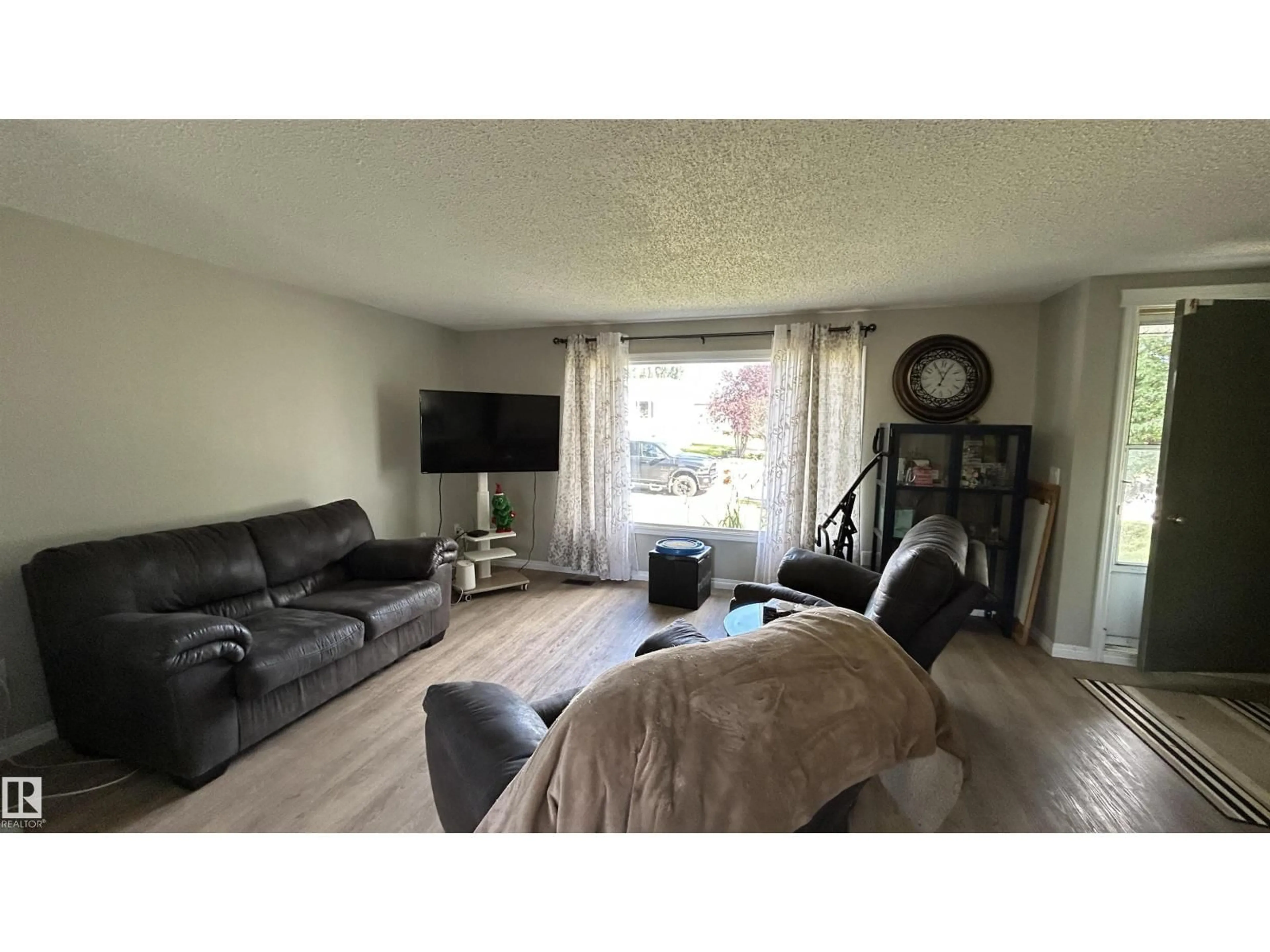 Living room with furniture, wood/laminate floor for 4308 45 AV, Bonnyville Town Alberta T9N1X2