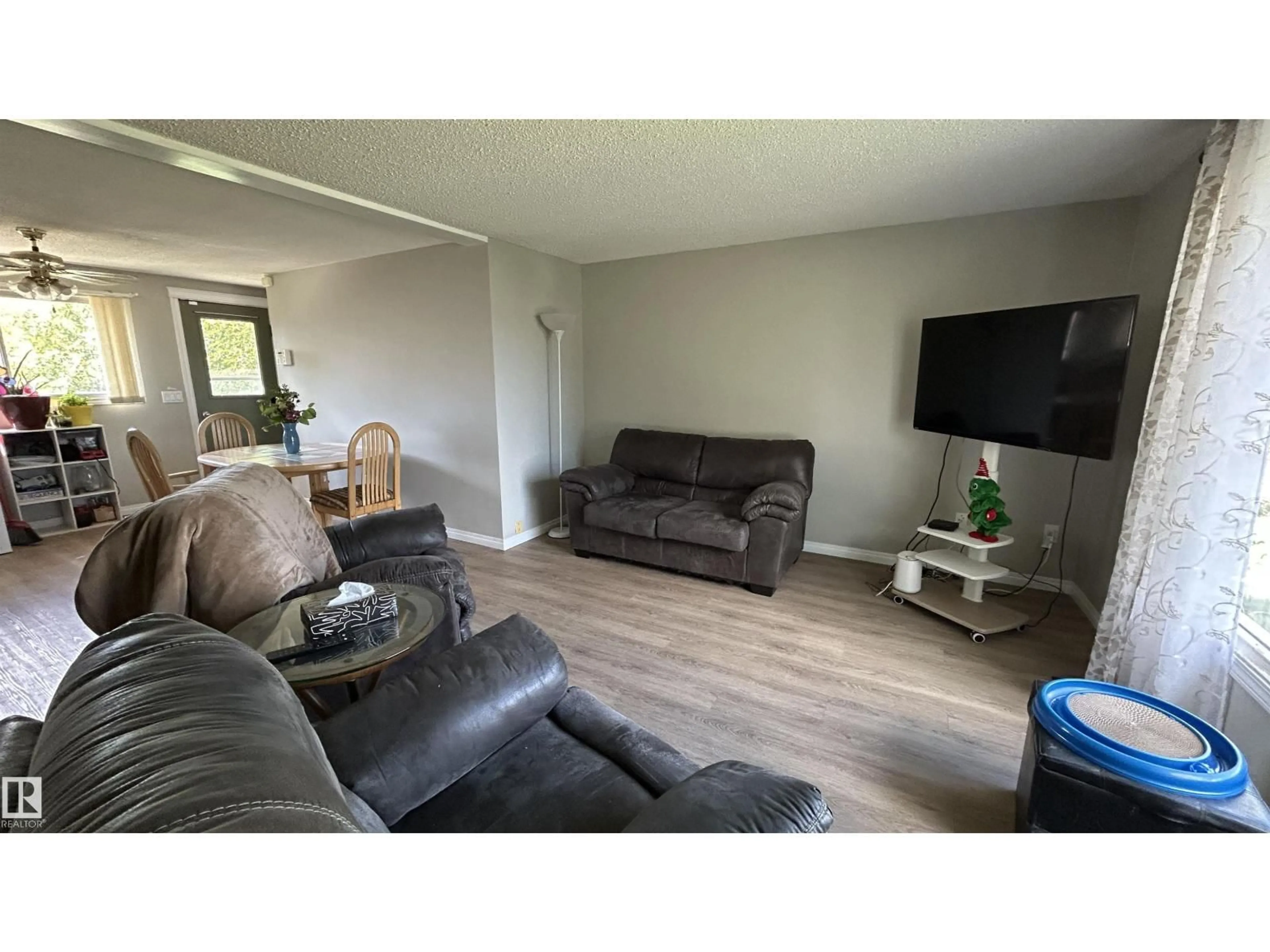 Living room with furniture, wood/laminate floor for 4308 45 AV, Bonnyville Town Alberta T9N1X2